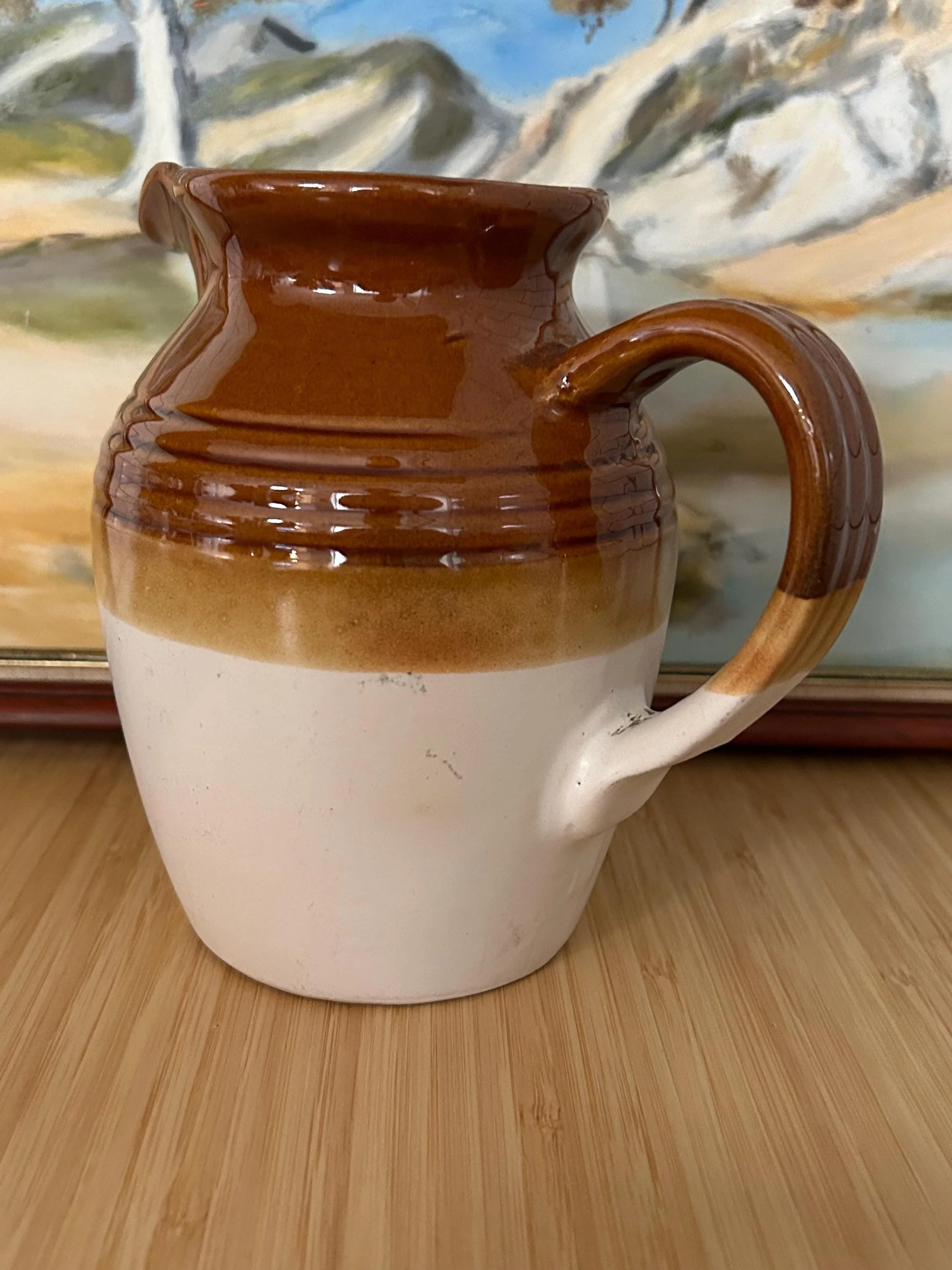 Close-up of pitcher showing ribbed banding and warm glossy finish