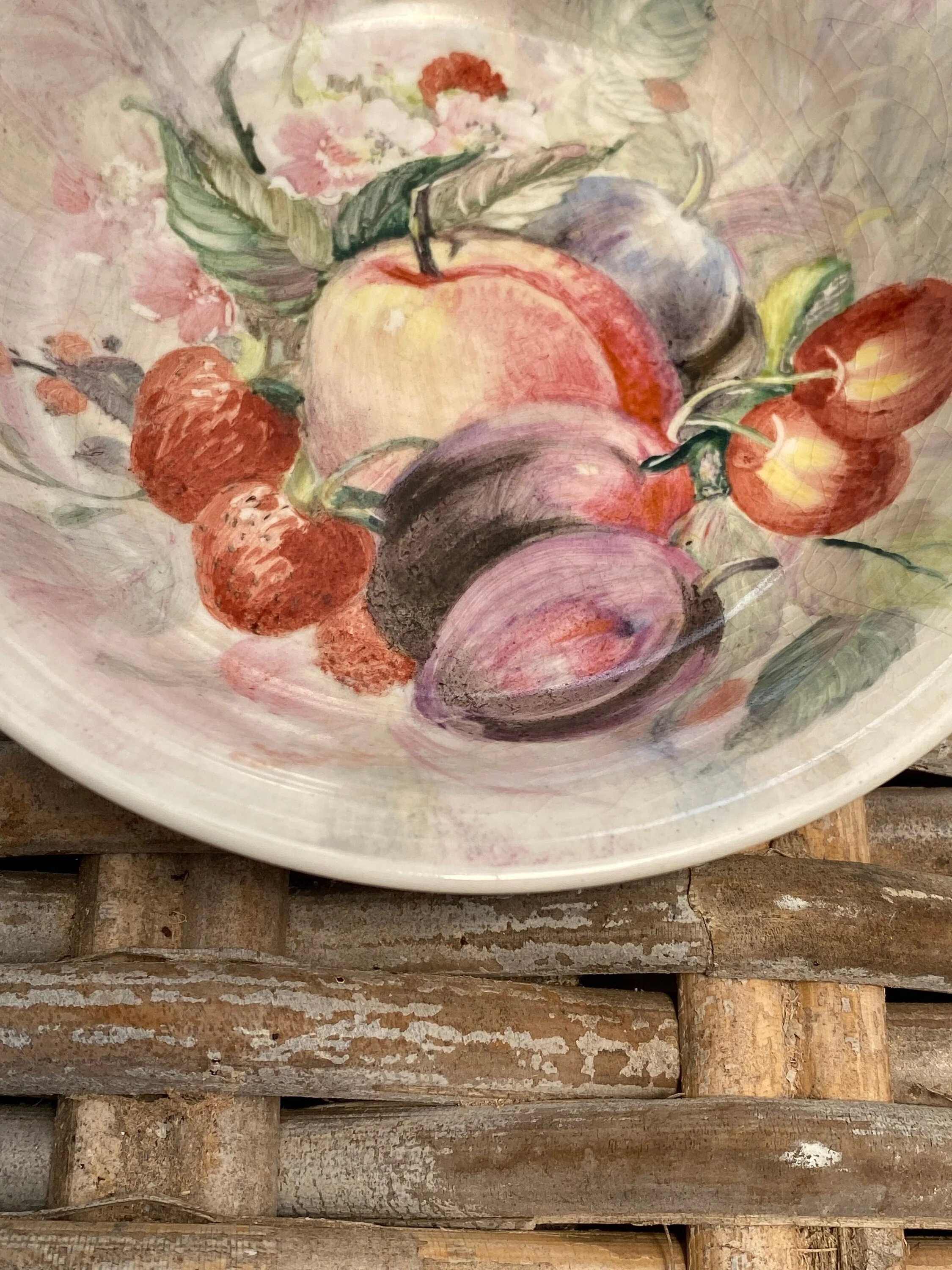 Close-up of painted fruit design with aged glaze