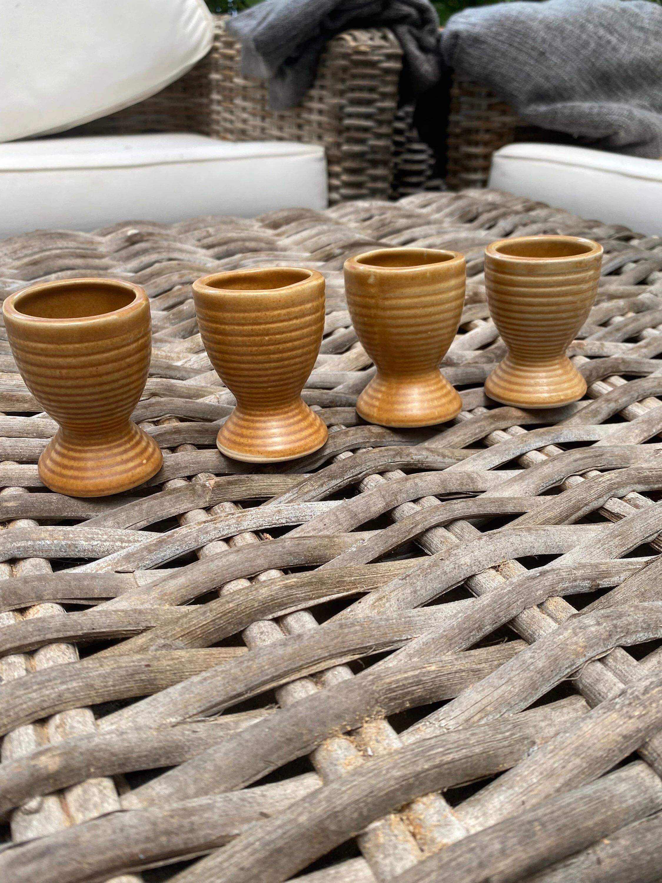 Full set of four egg cups grouped together outdoors