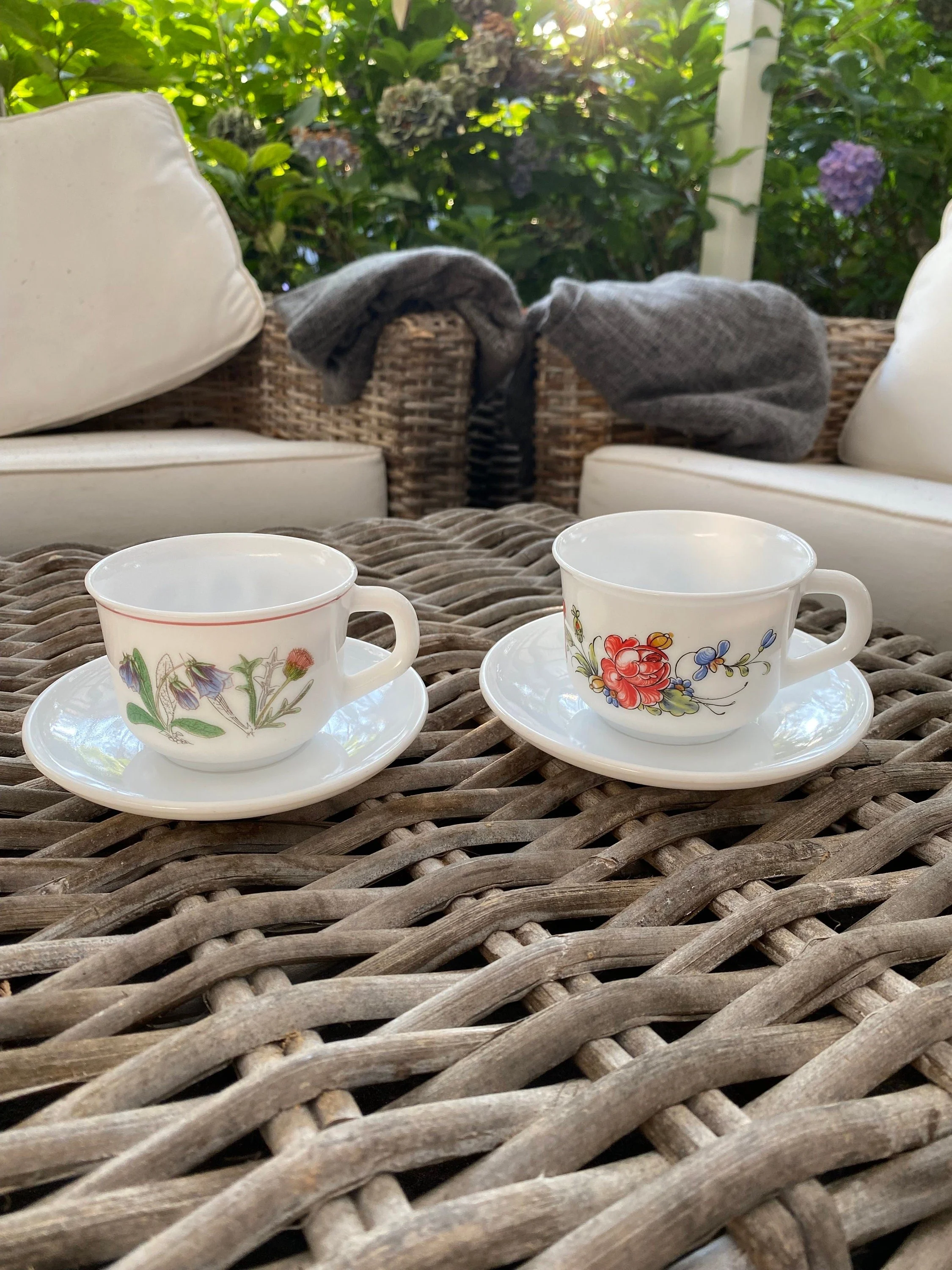 A vintage Arcopal cup & saucer set featuring two distinct floral designs. Made in France in the 1970s, crafted from opaline milk glass—durable, elegant, and collectible.