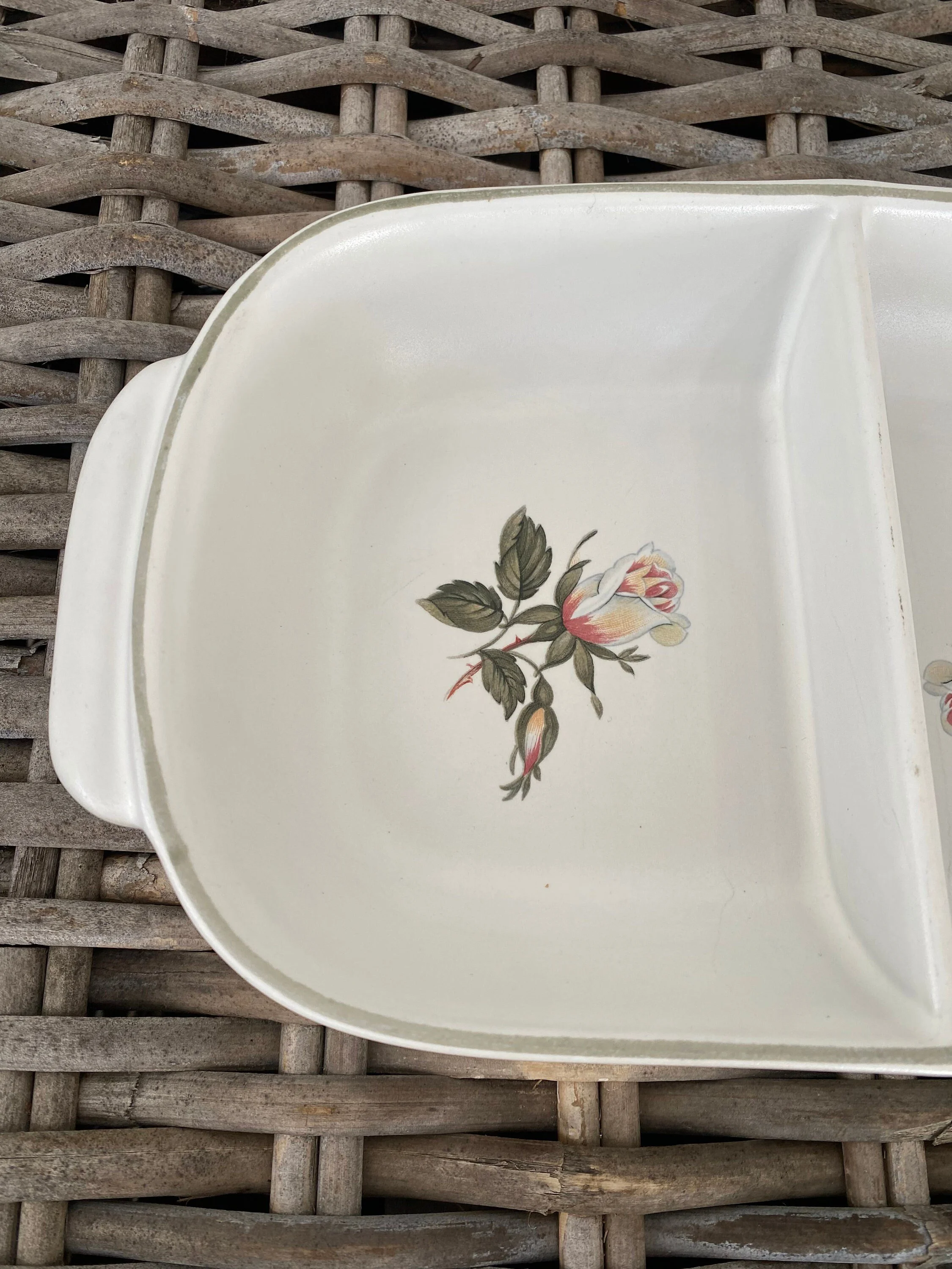 Close-up of rose motif inside divided dish