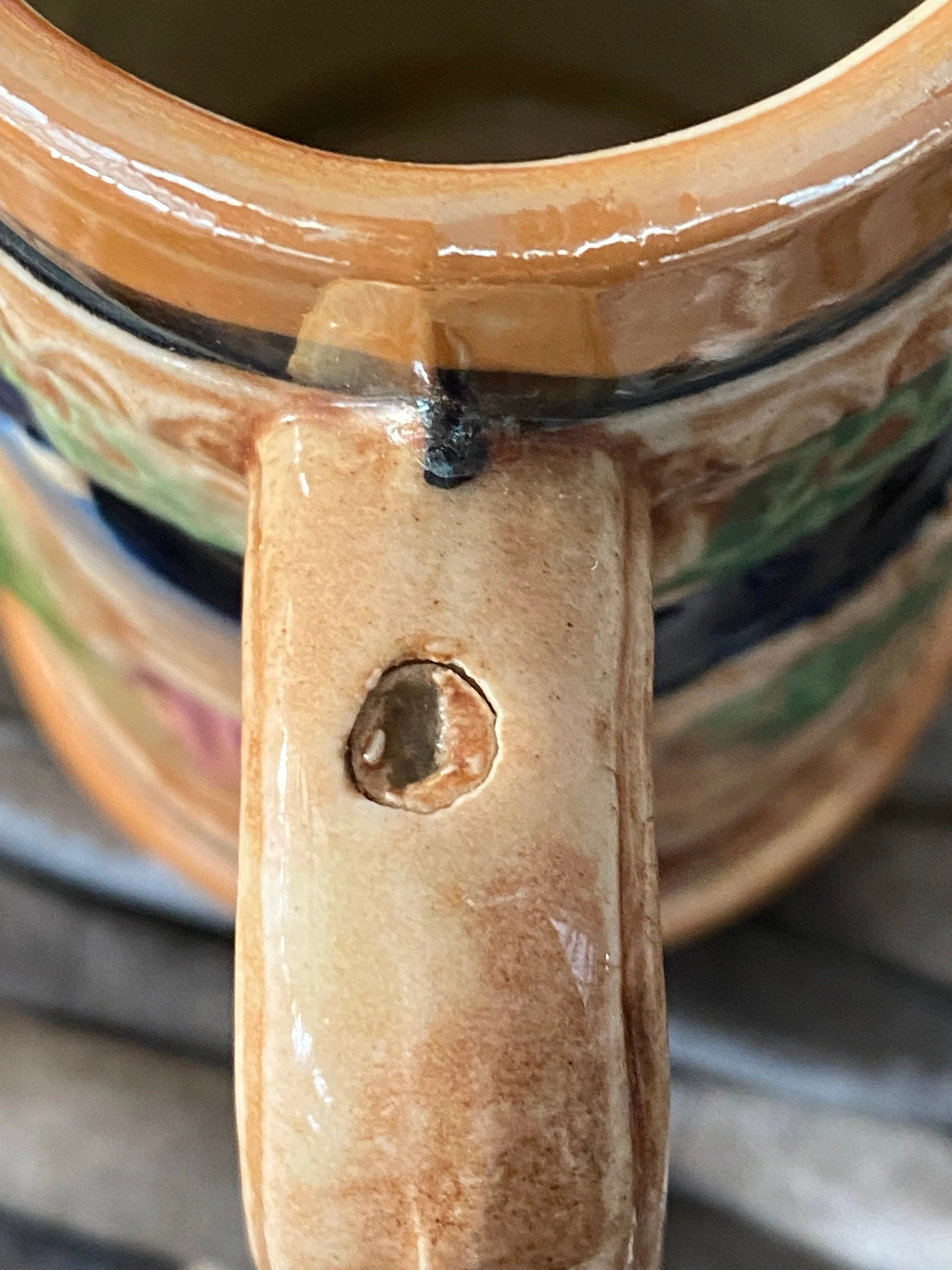 Close-up of handle showing minor chip at the top and glaze details.