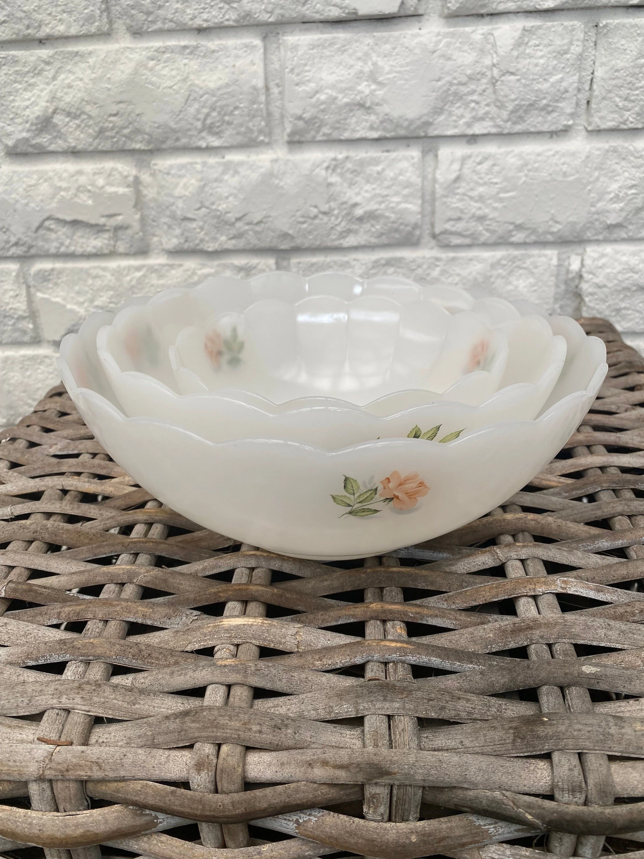 A vintage set of 3 Arcopal France nesting bowls from the 1970s, featuring the 'Pink Rose' floral pattern and scalloped rims. Classic French opal glassware.