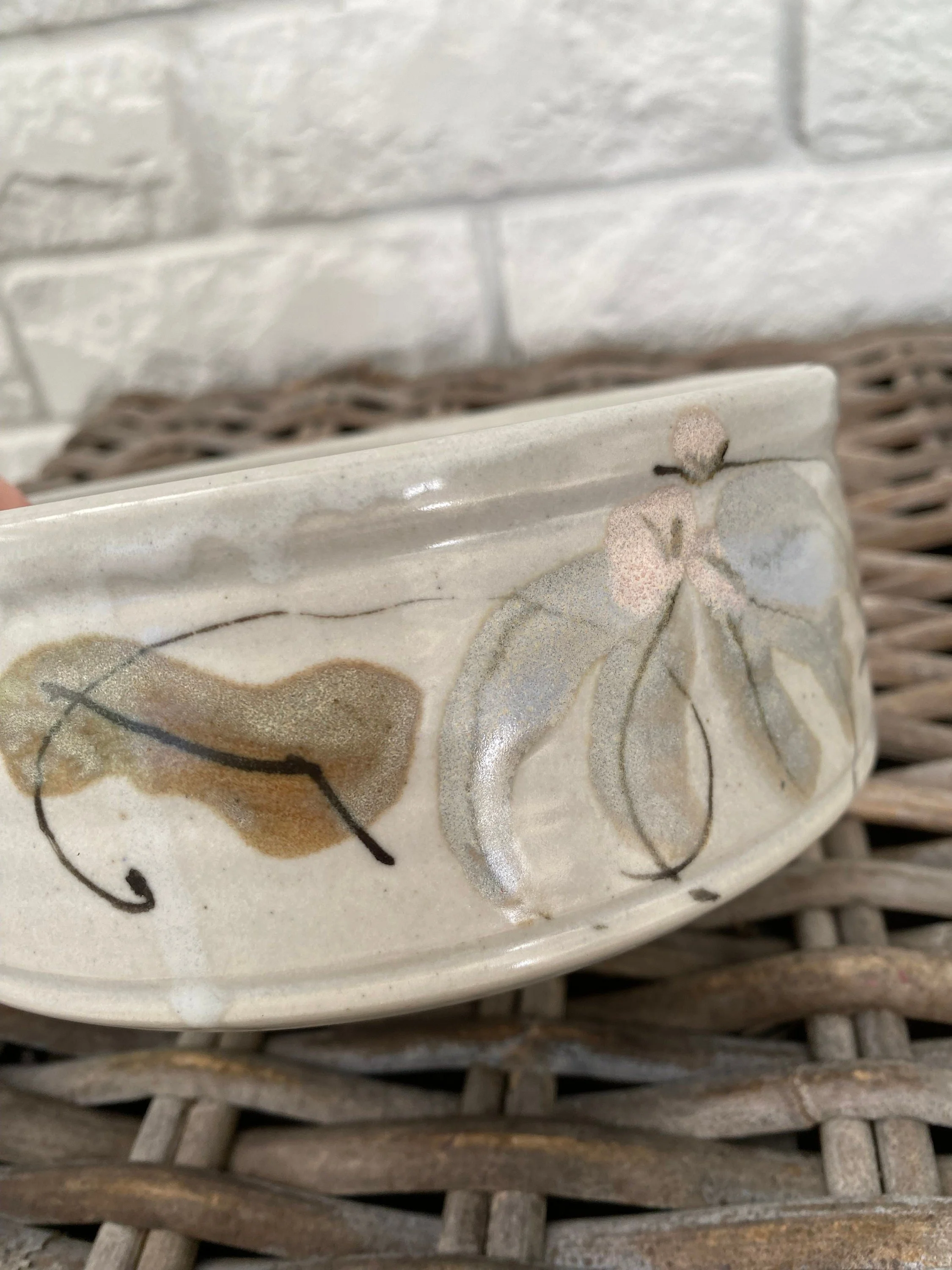 Detail of floral motif featuring pink blossoms and eucalyptus leaves