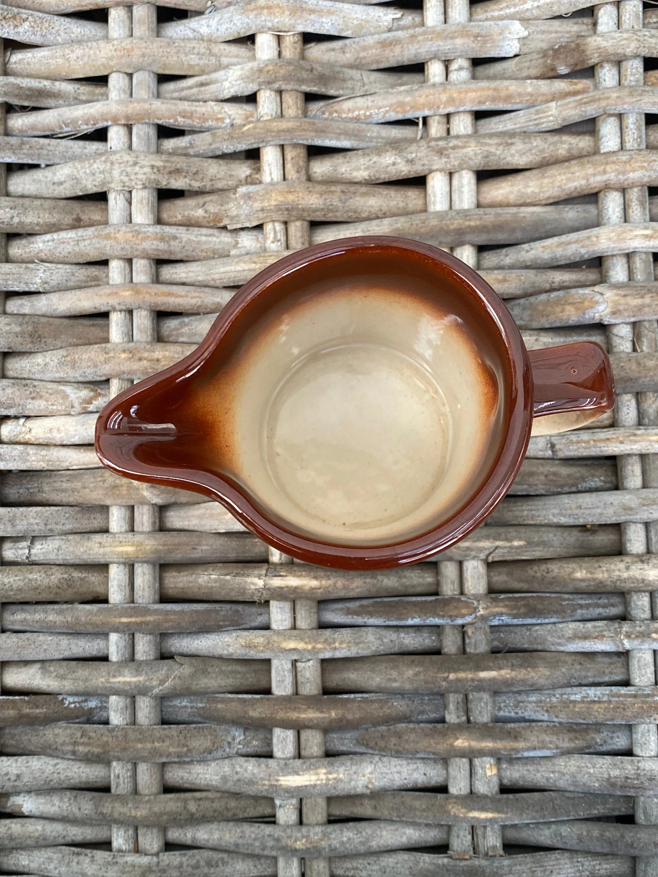 Top view showing scalloped spout and glossy brown interior