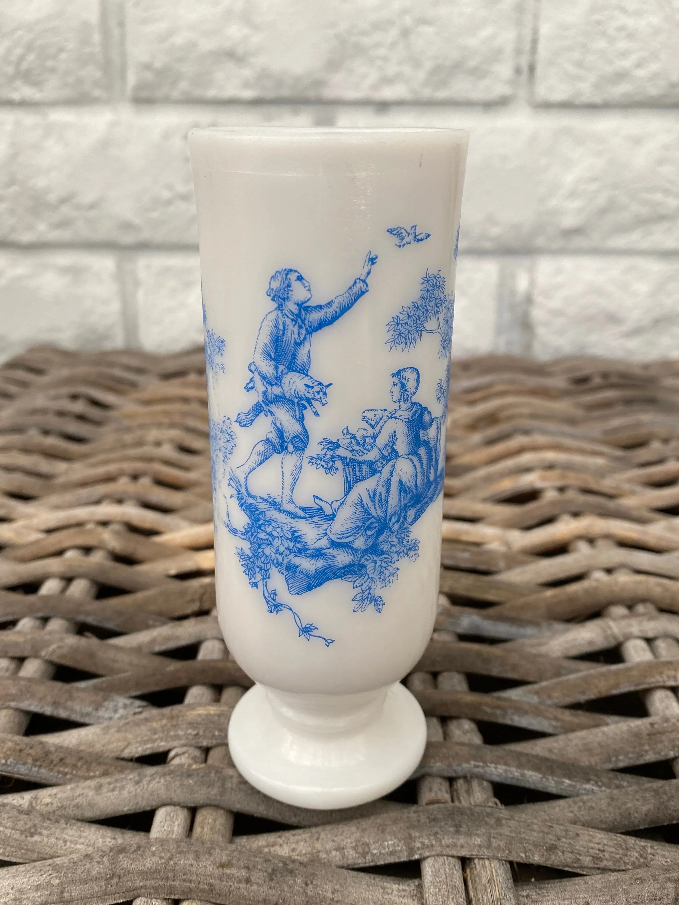 Vintage 1970s Avon milk glass bud vase with a delicate blue and white design. Perfect for Hamptons, country, and cottage-style interiors.