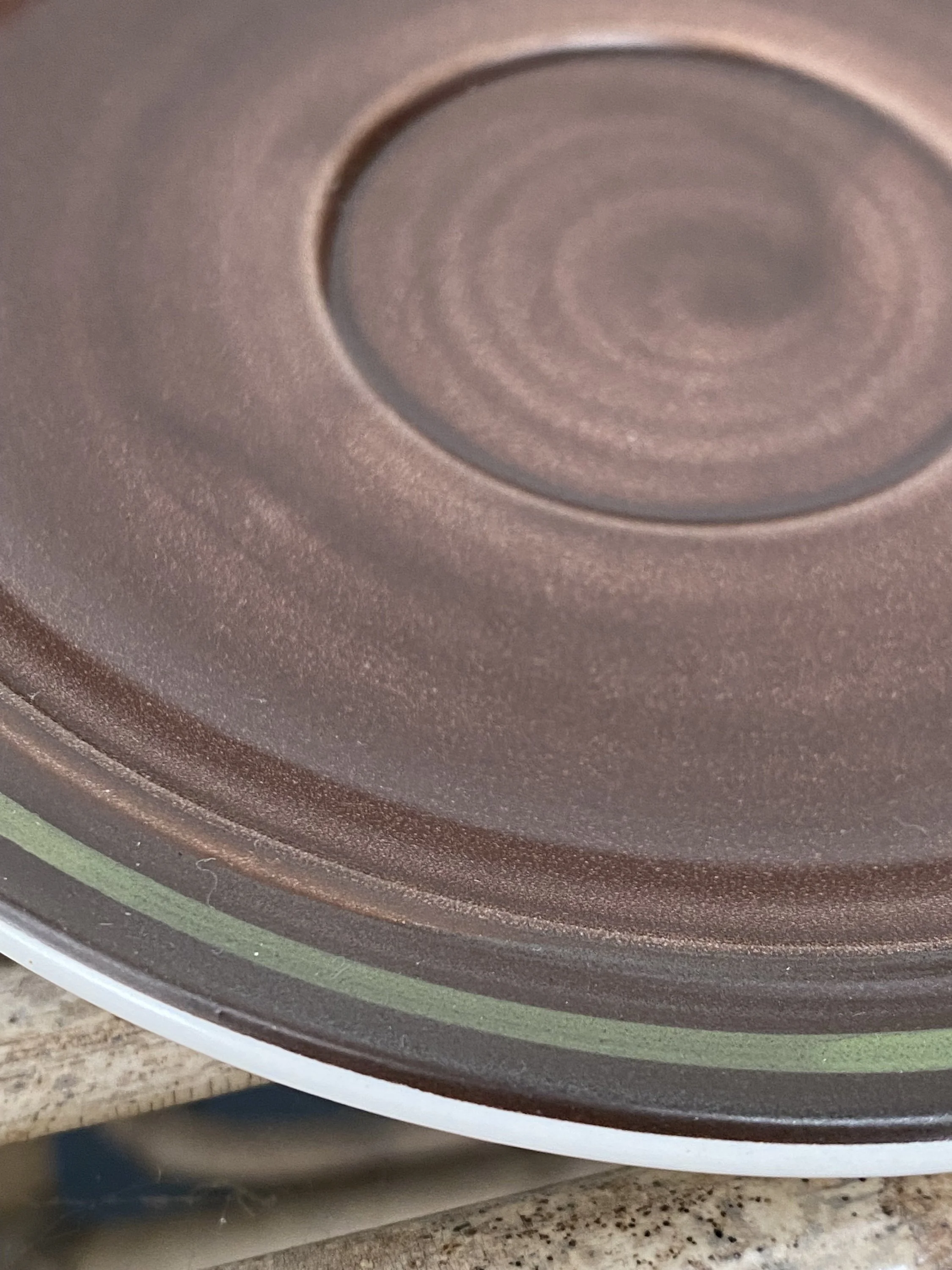 Close-up showing glaze swirl texture in the centre of saucer
