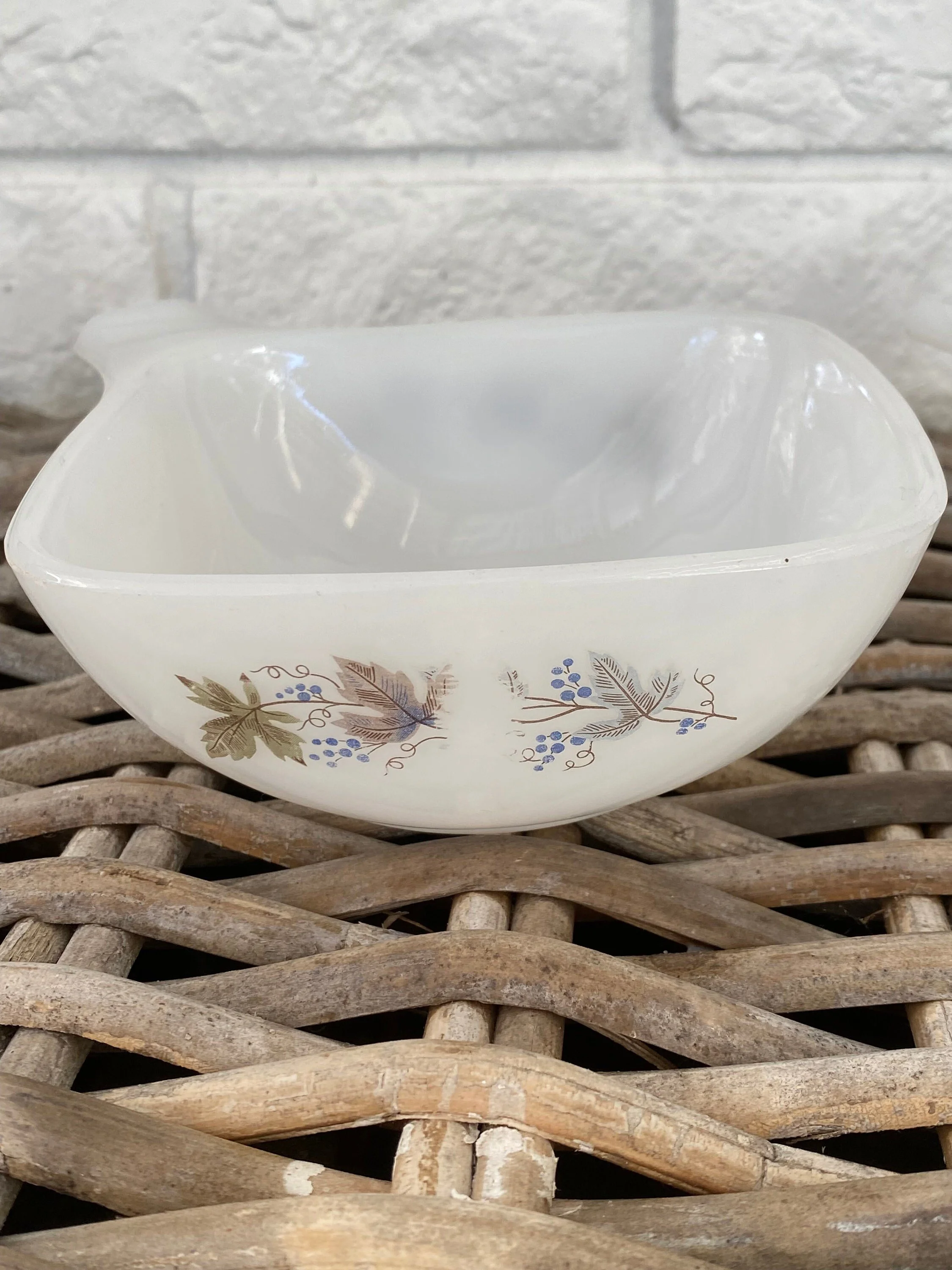Side view highlighting grapevine motif and curved bowl shape