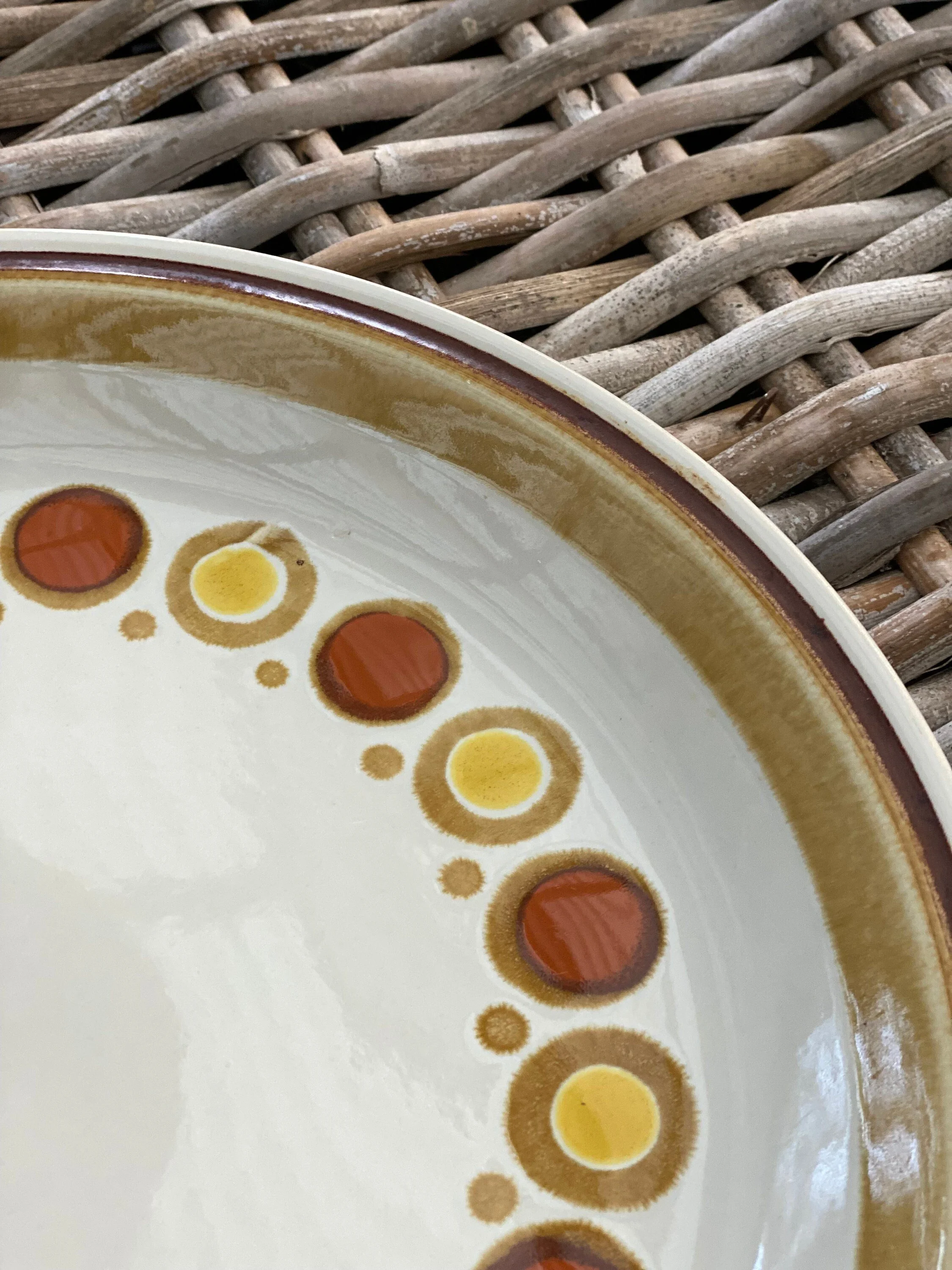 Detail of yellow and orange circles on cream background