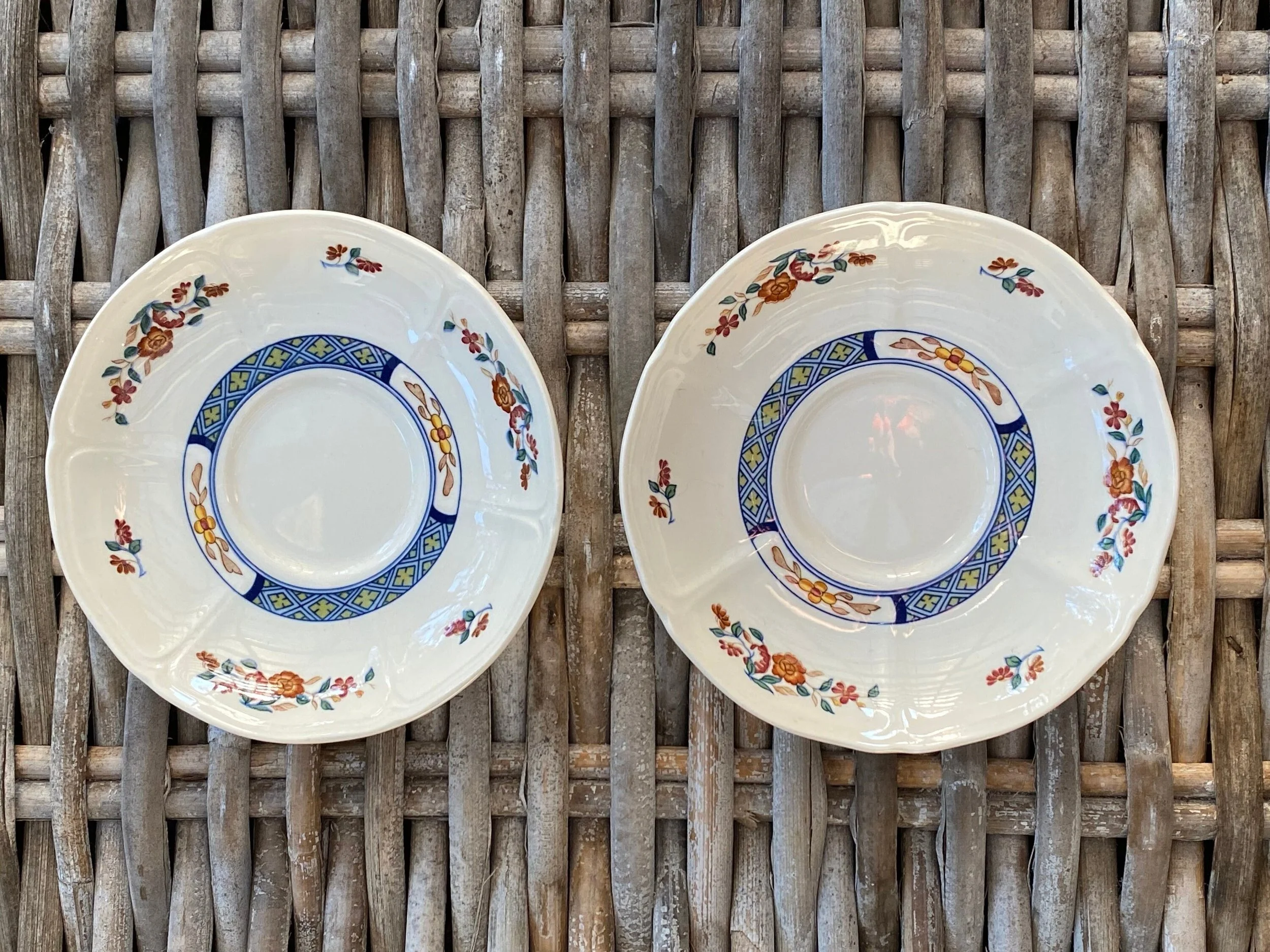 Overhead view of two Wedgwood Chinese Teal saucers side by side on wicker