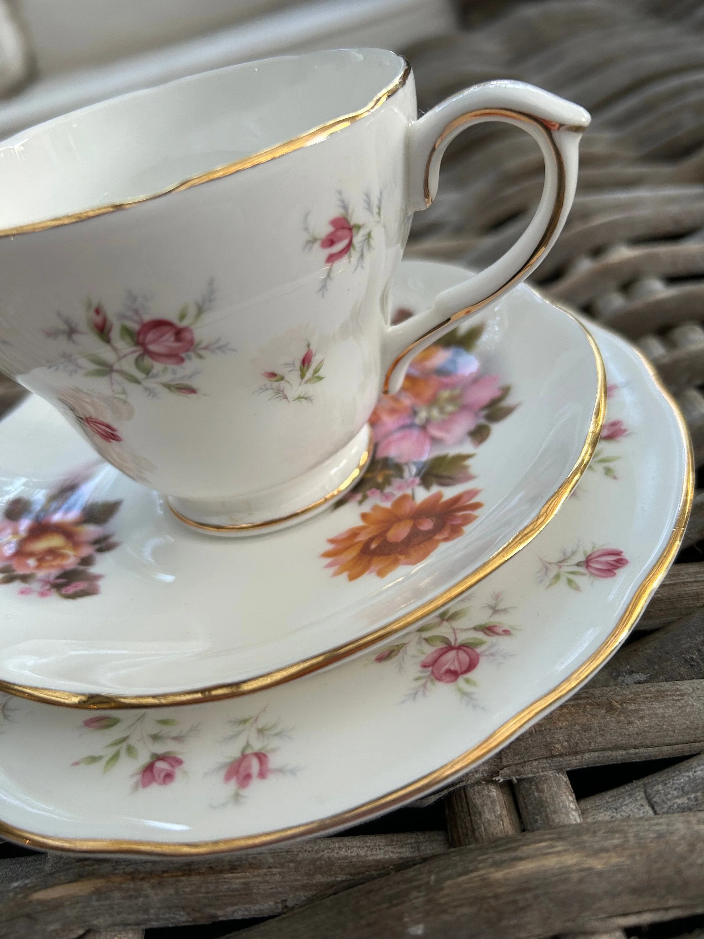 Close-up of cup and plate showing floral Marie design and gold trim