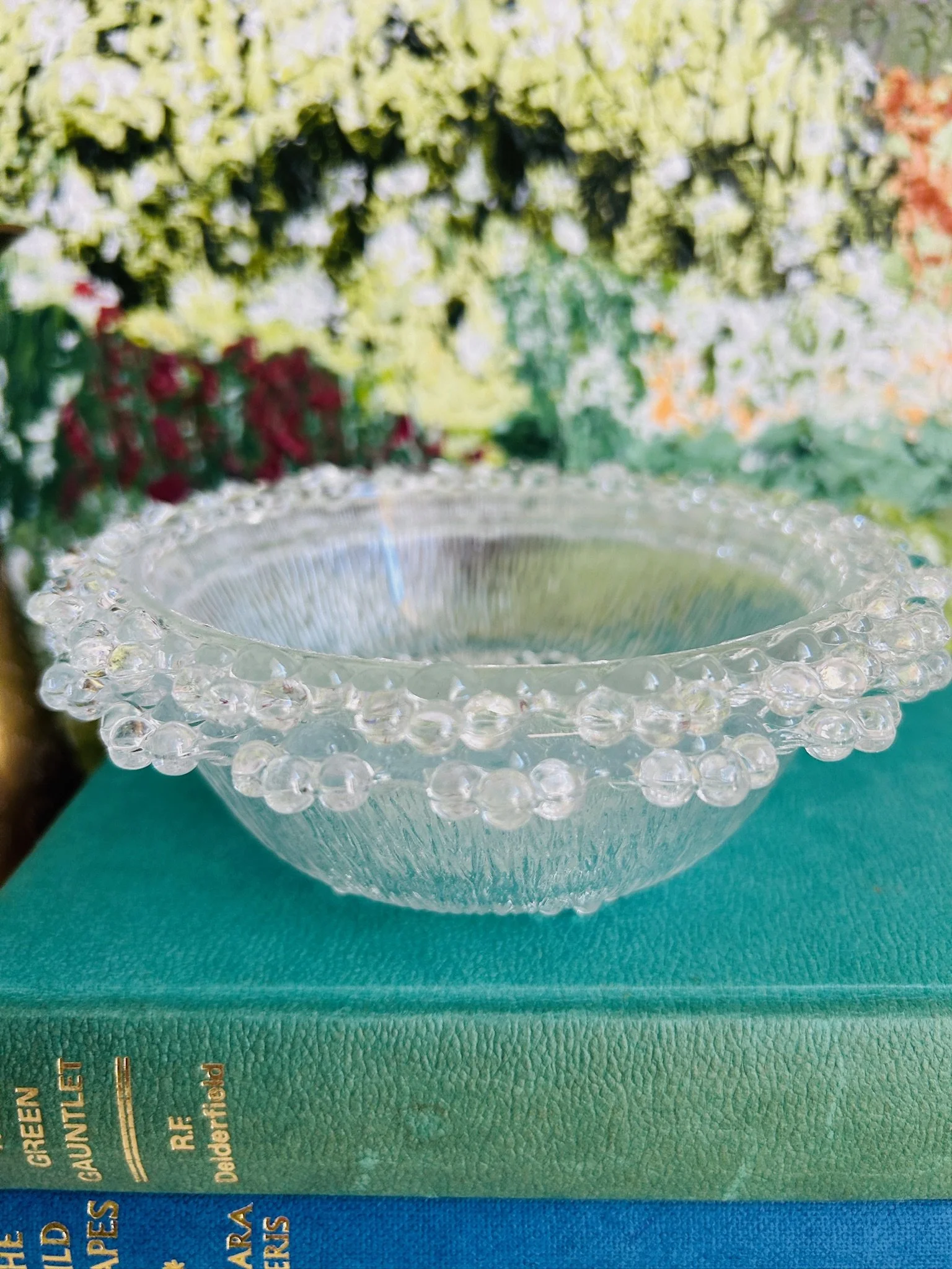 Front view of one Masserini Barocco clear pressed glass bowl showing the textured sides and bubble edge rim.
