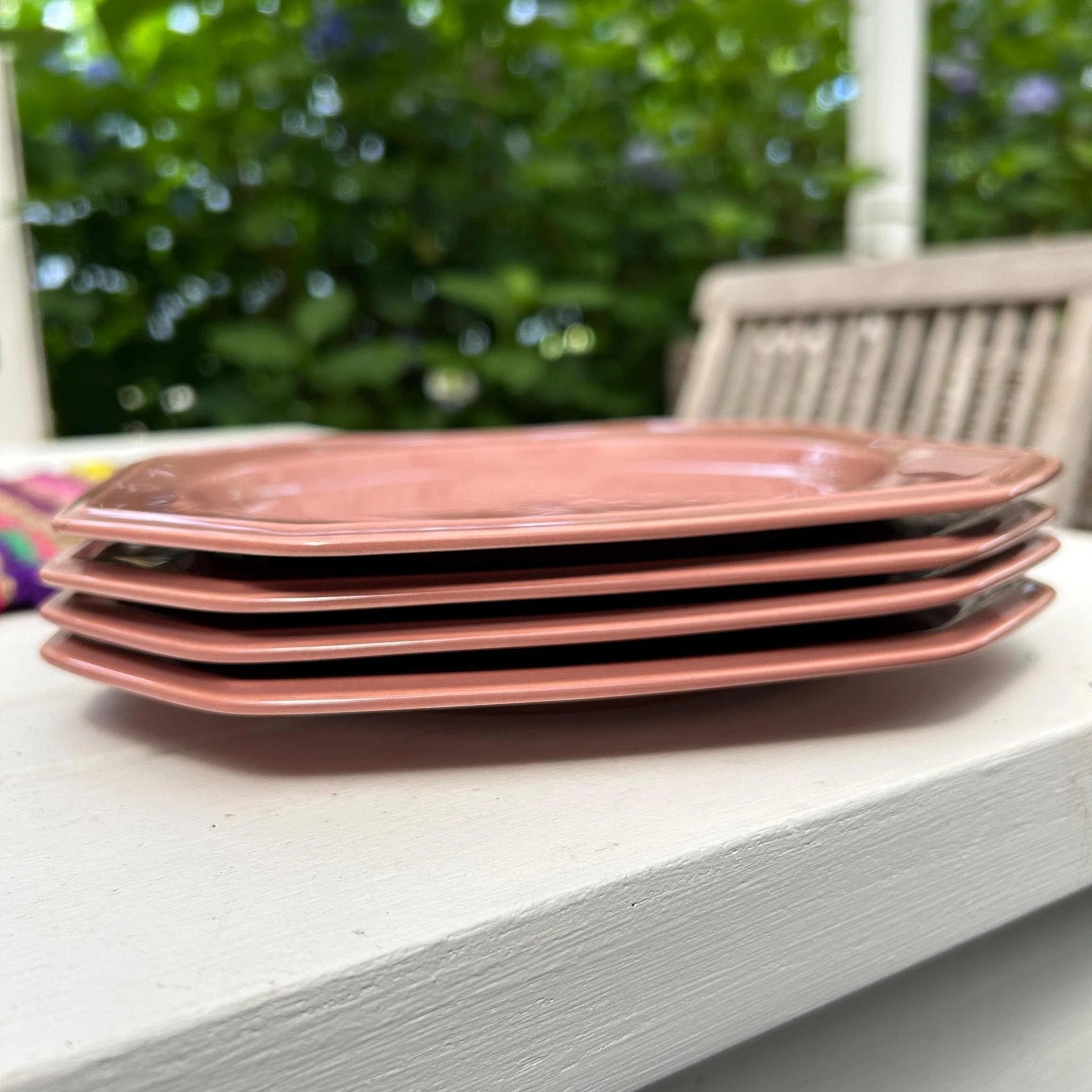 Side angle of stacked plates showing glossy finish