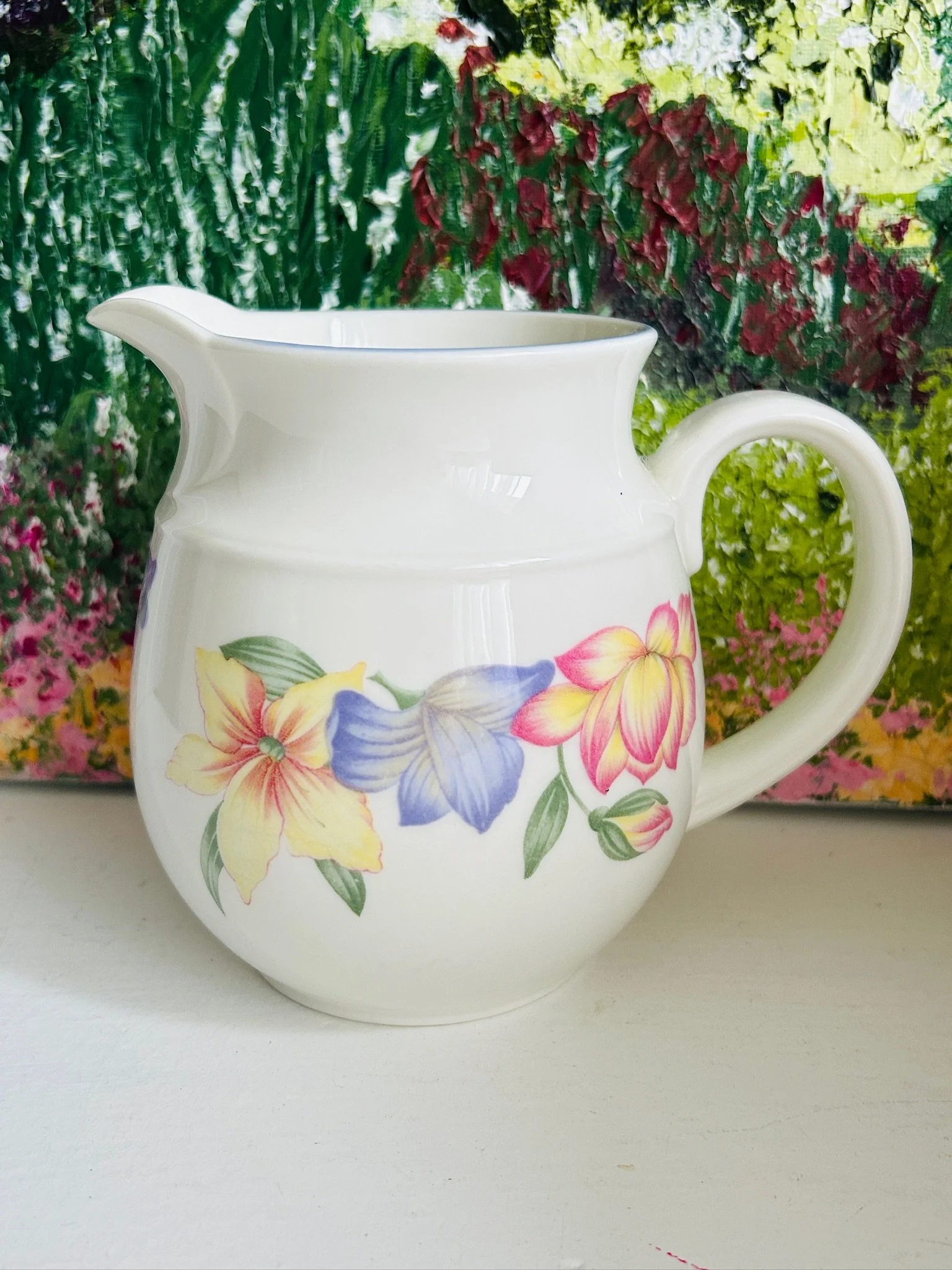 Front view of Royal Doulton Blooms creamer jug with pink, yellow, and purple floral design