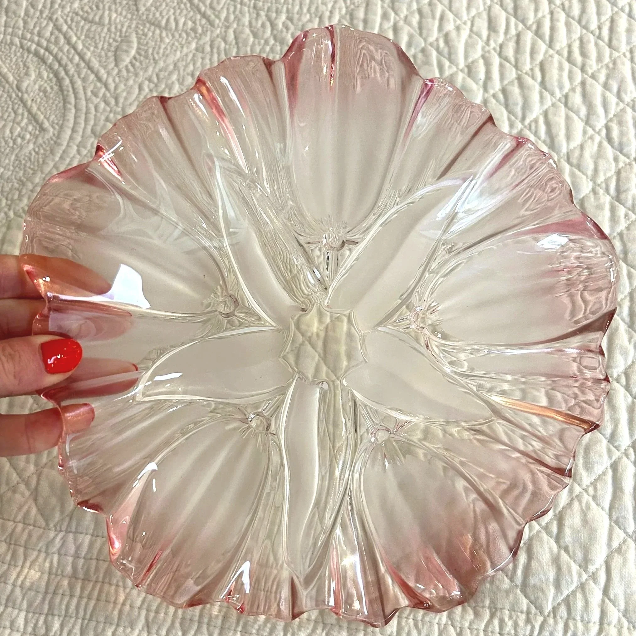 Close-up of pink plate held by hand – frosted tulip pattern visible