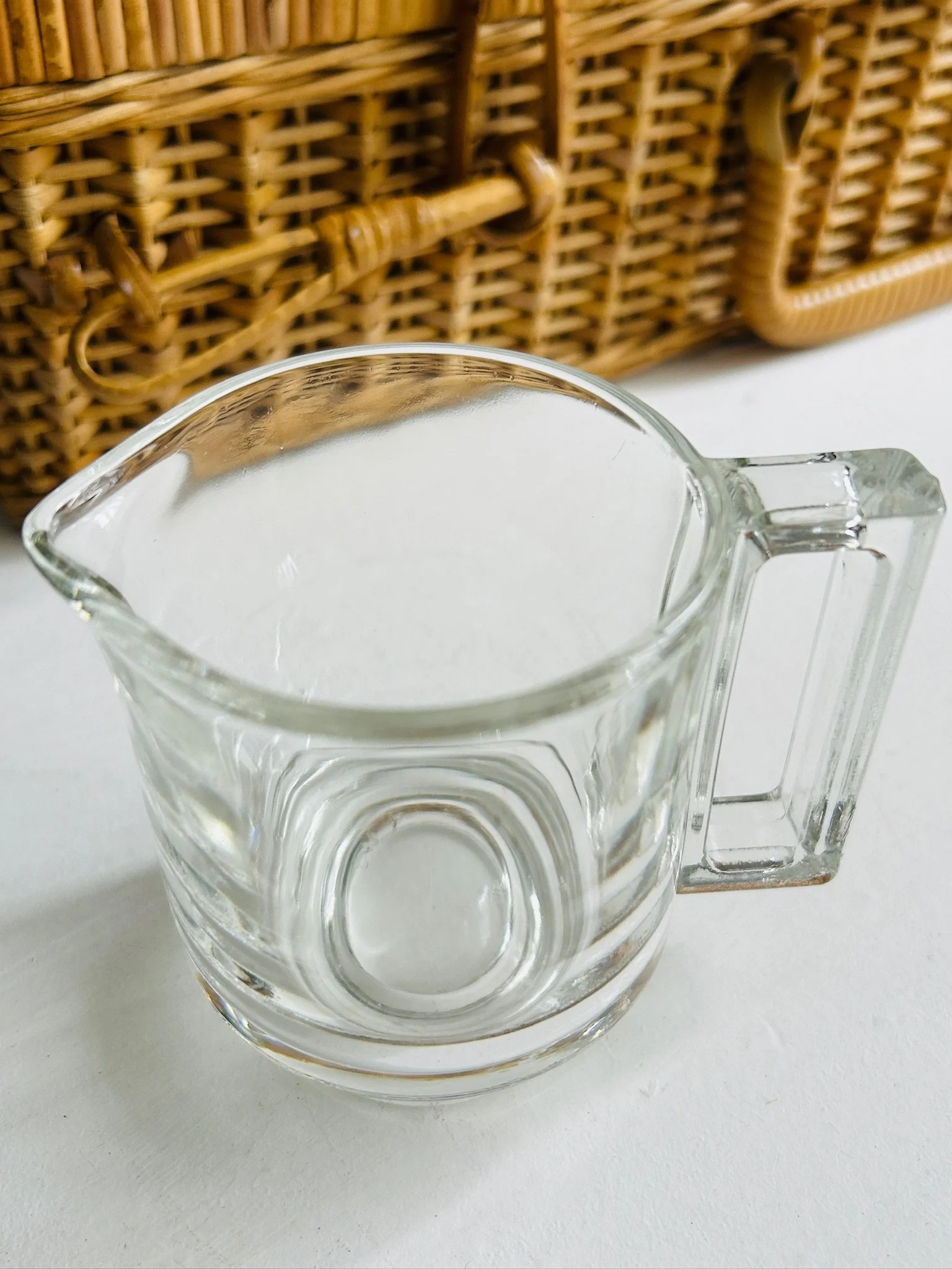 Angled top view of the Joe Colombo Arno creamer showing the oval opening, spout shape, and clear geometric handle