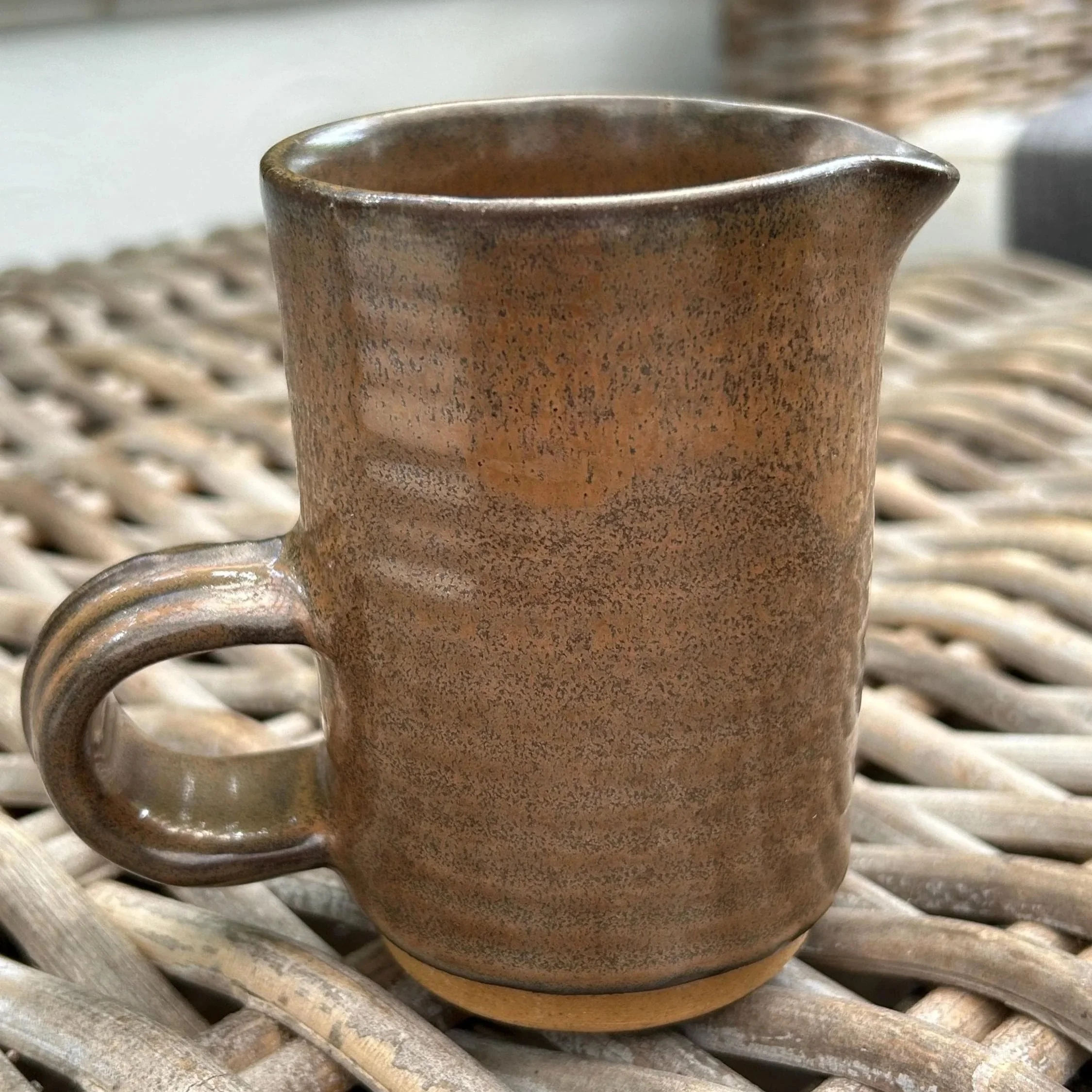 Alternate side showing curved handle and pour spout