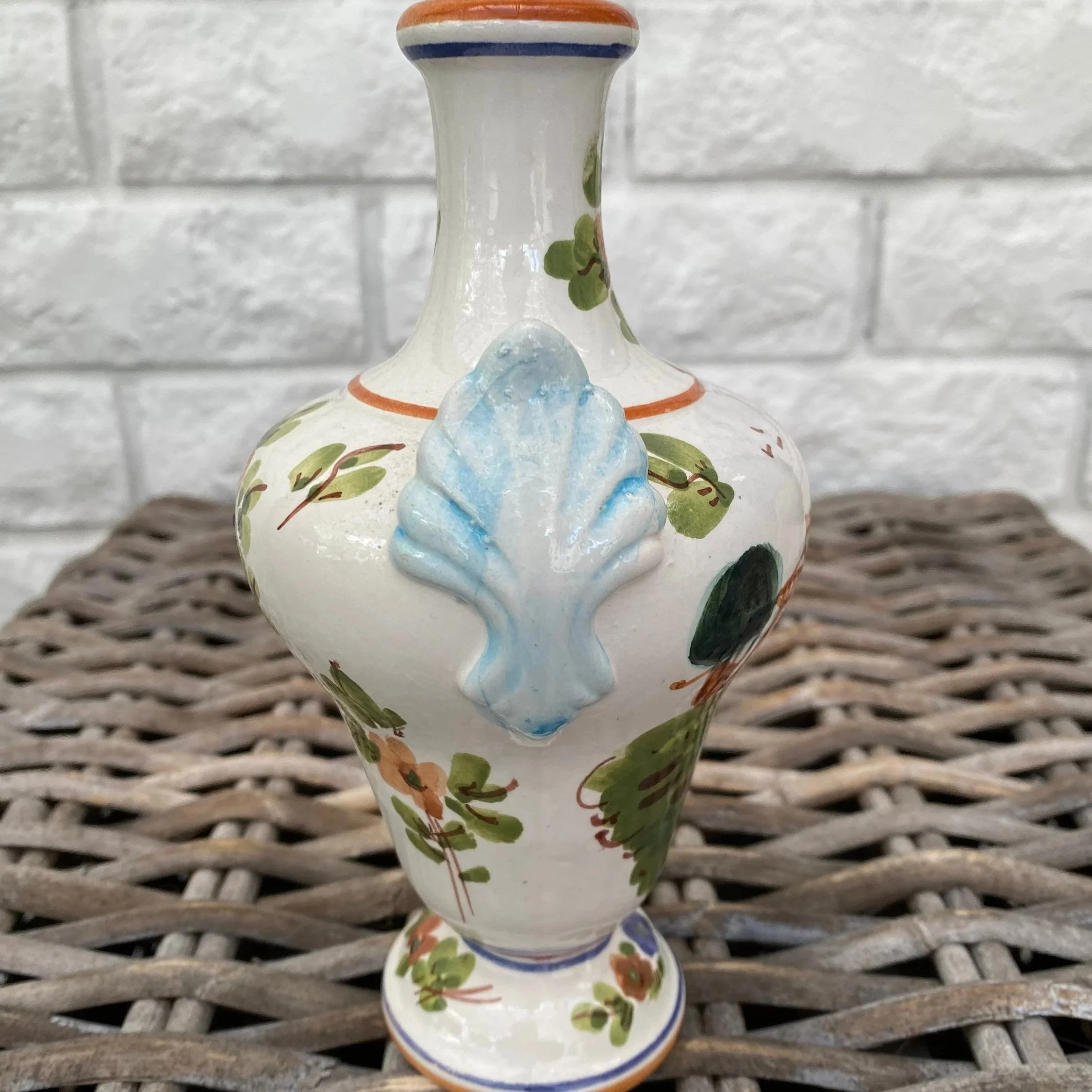 Rear angle showing blue sculptural leaf handle and foliage design