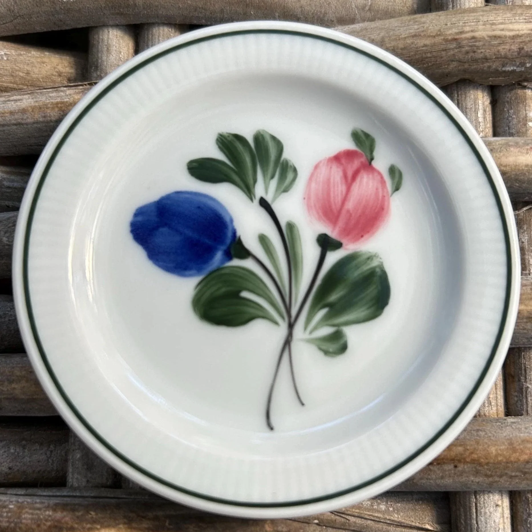 Overhead view highlighting blue and pink flowers with green edging