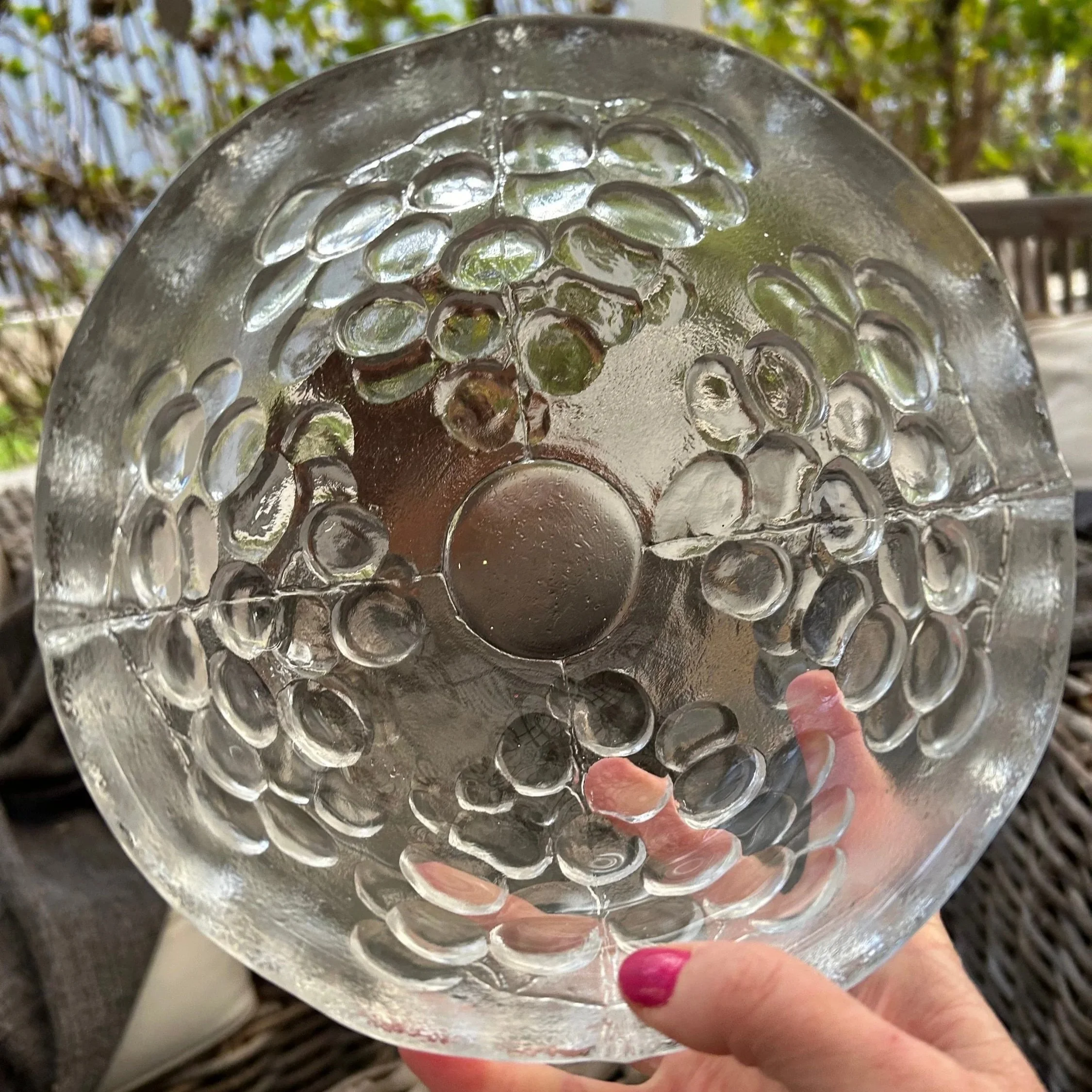 Top-down interior view revealing grape motif and glass clarity