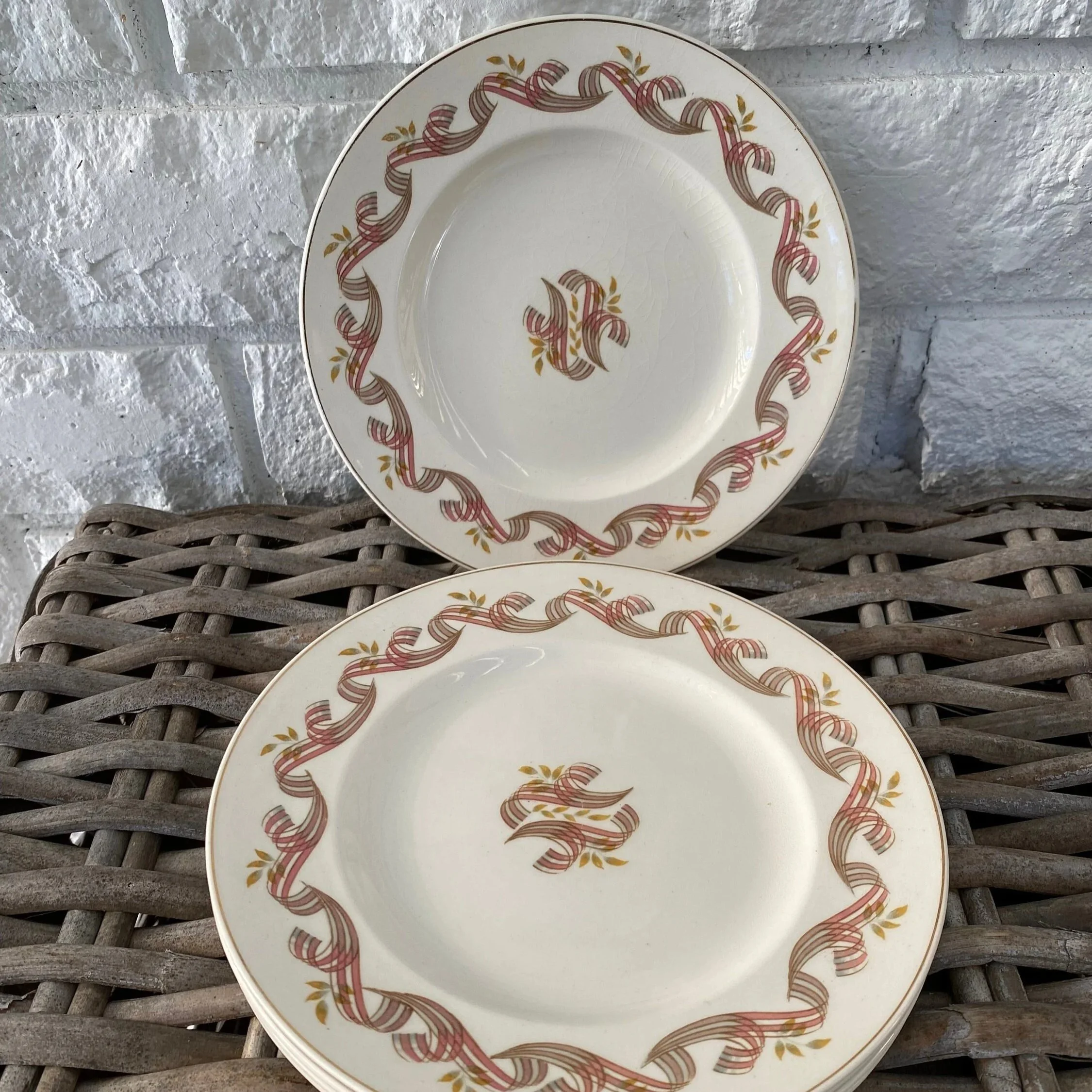 Two plates displayed upright and flat against wicker background