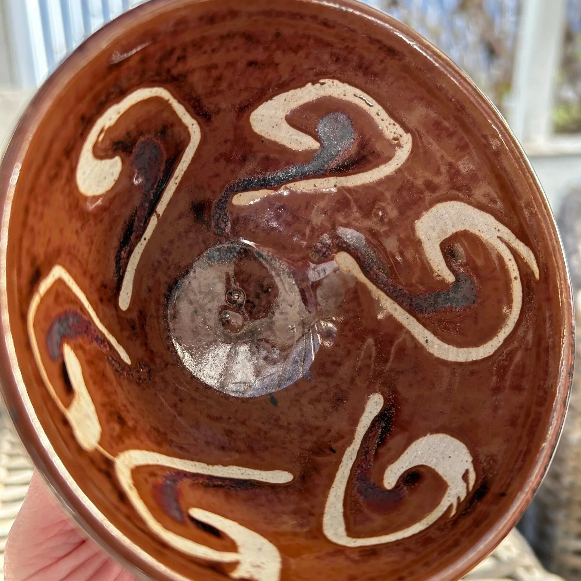 Interior of studio bowl showing cream swirl glaze pattern