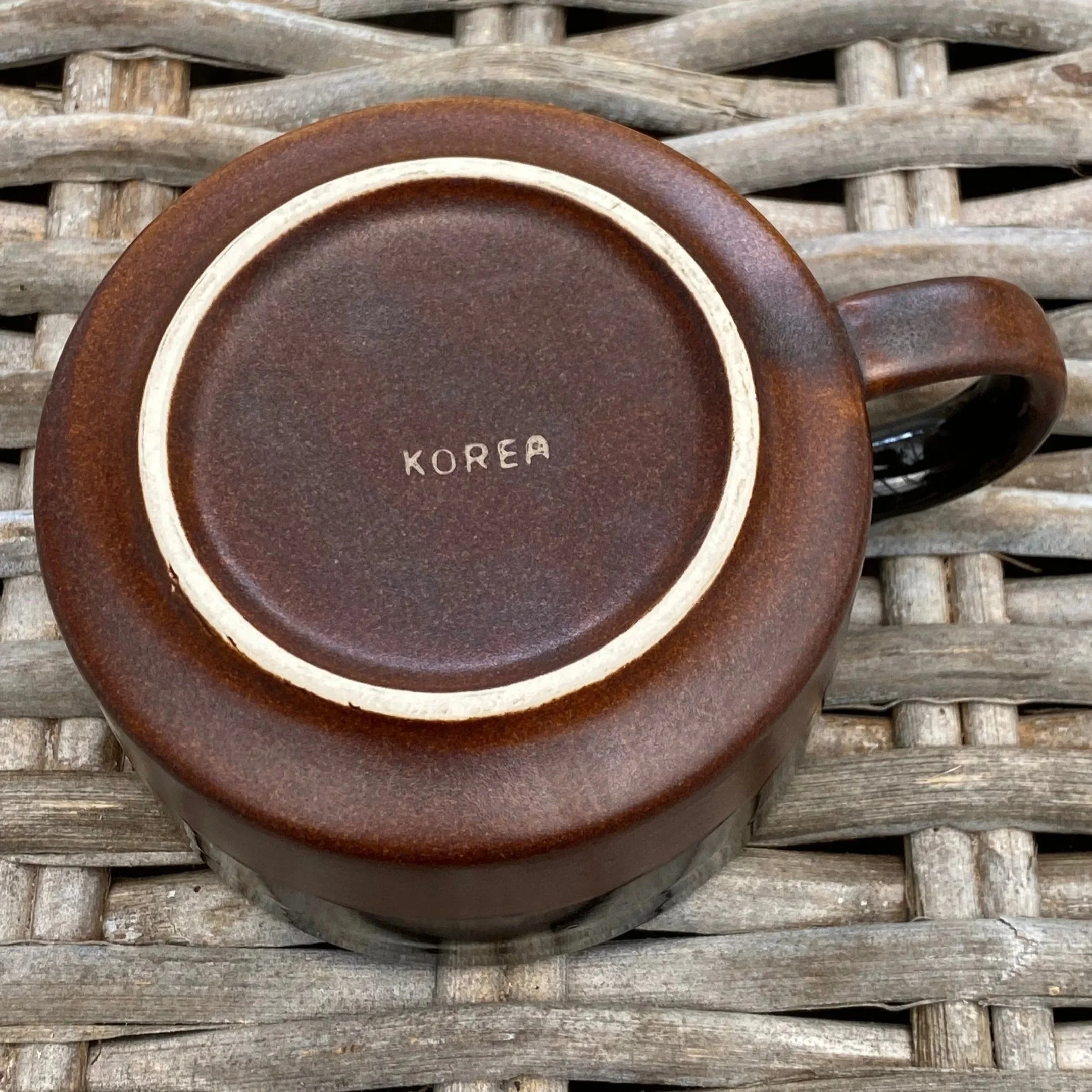 Close-up of base showing brown glaze and foot ring detail