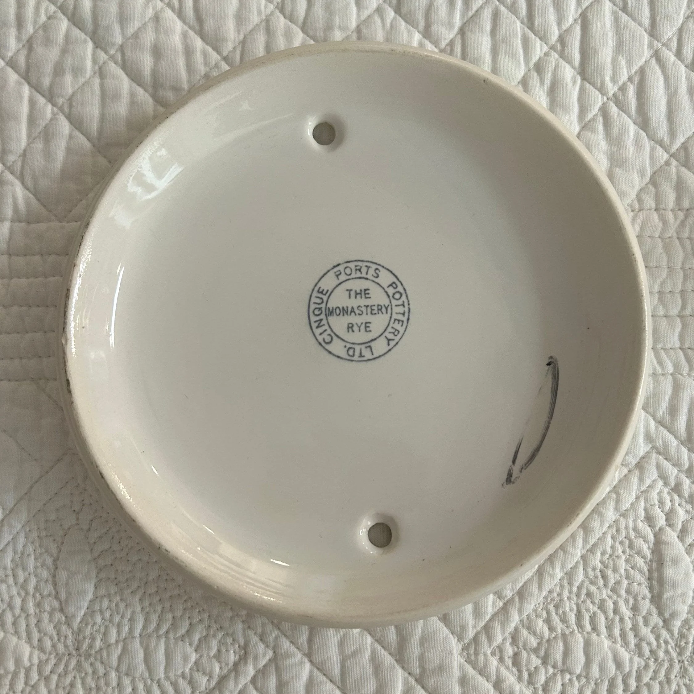 Back of Cinque Ports Pottery wall plaque showing The Monastery Rye stamp and pre-drilled holes for mounting