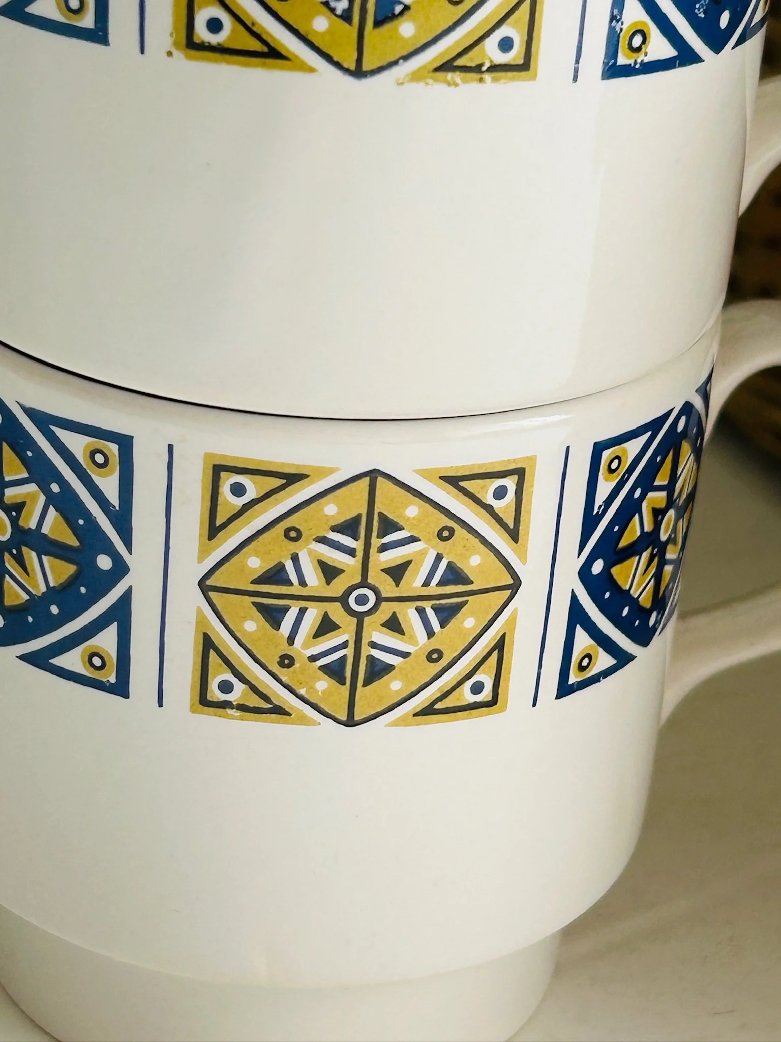 Detailed close-up of the geometric Midas pattern on the side of the cup.