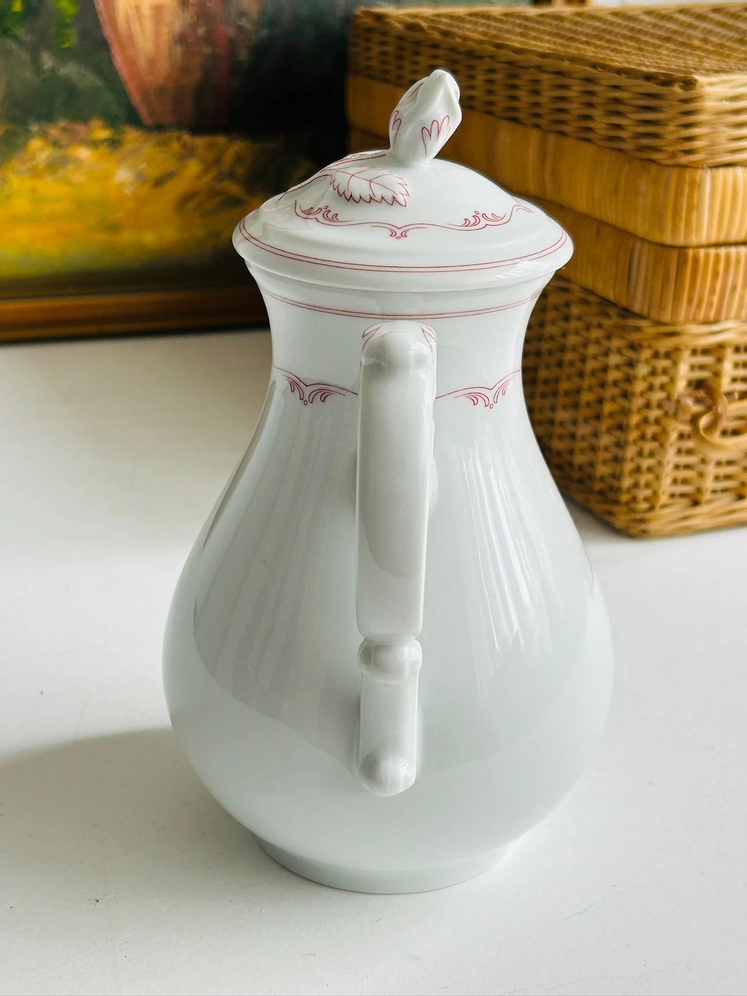 Rear view of the coffee pot showing the full handle profile and tapered porcelain body.