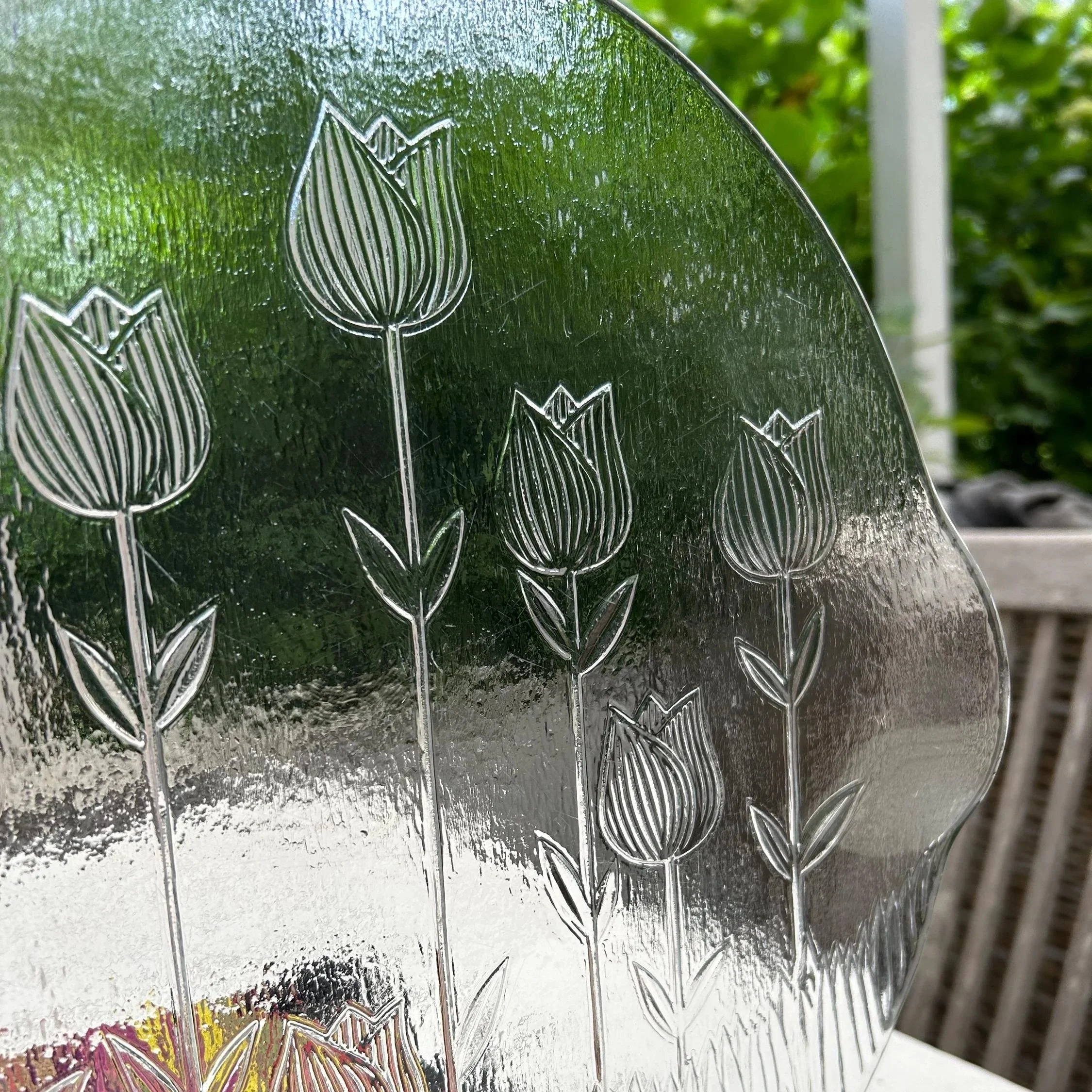 Detail of tall etched tulip stems and flowers.