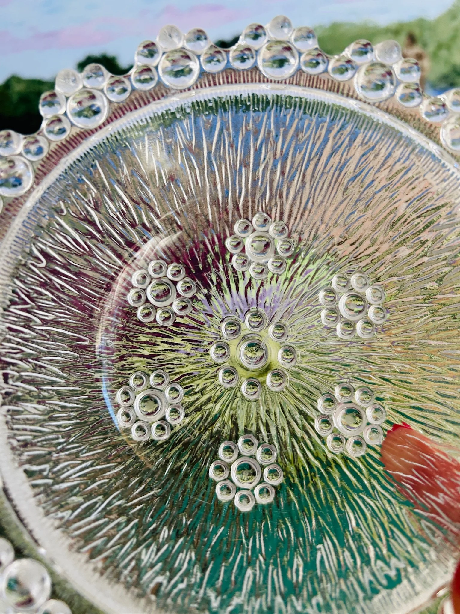 Overhead view of the bowl interior showing the radiating textured pattern and clustered bubble motif in the centre.