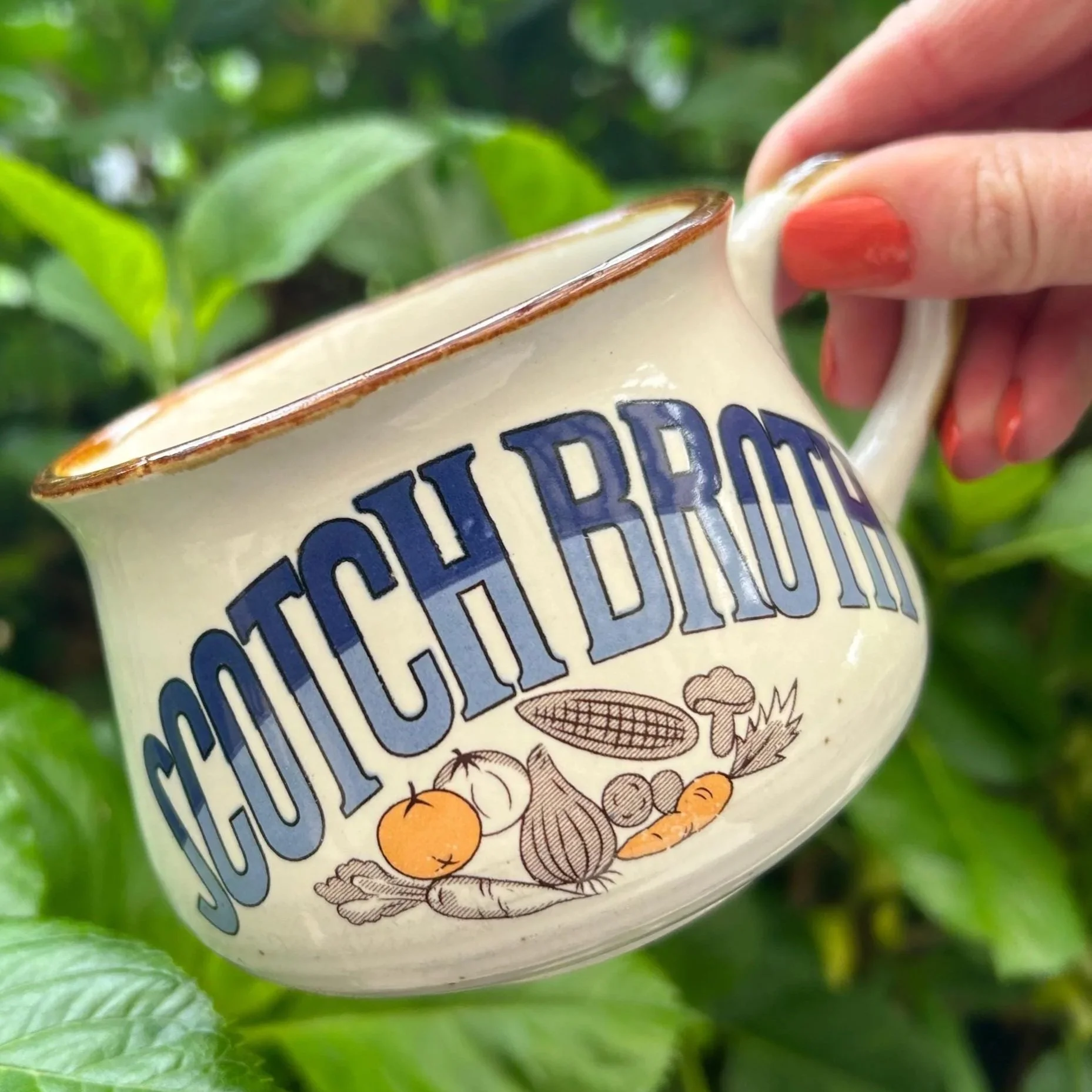 Side profile of “Scotch Broth” mug showing illustrations and bold text