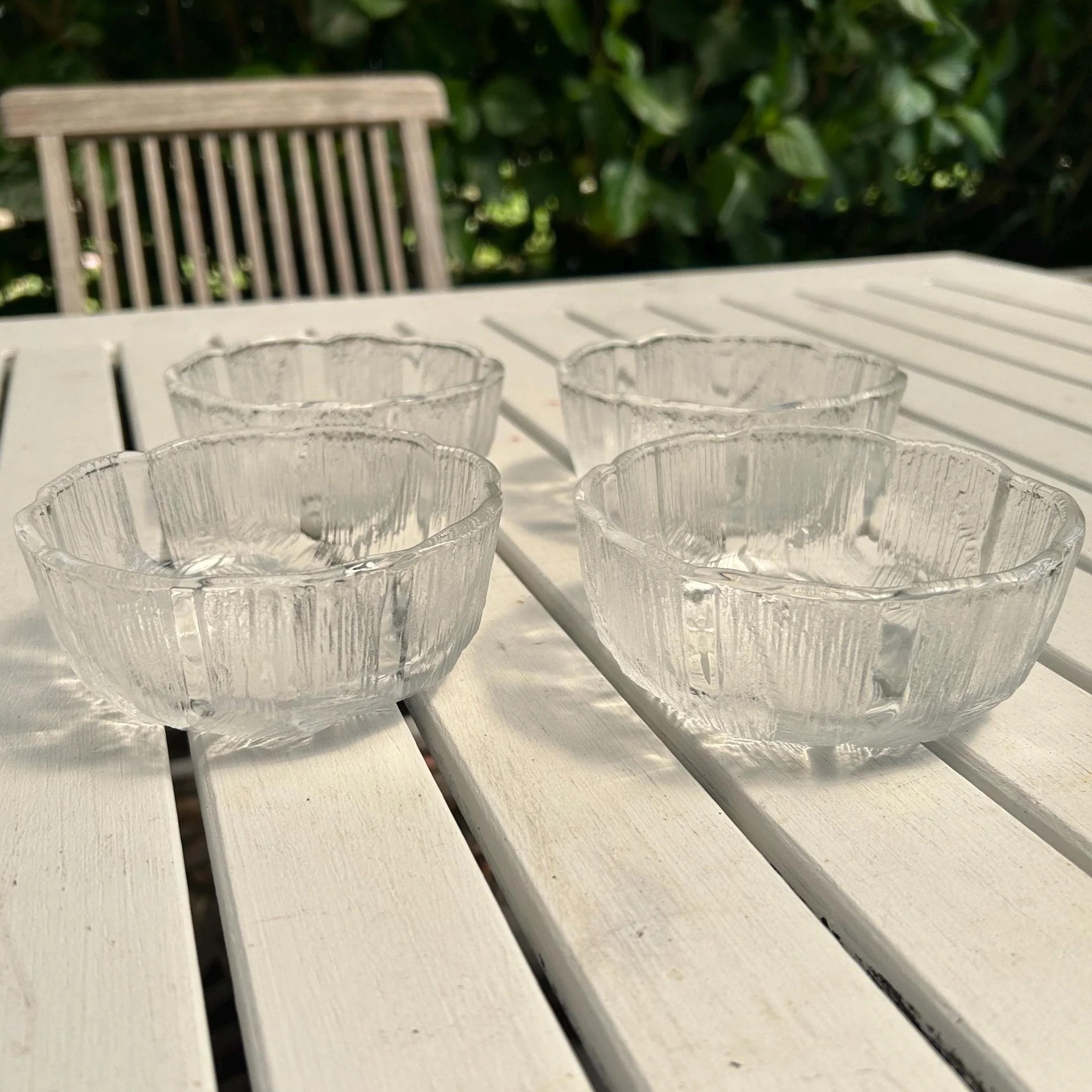 Set of 4 Mikasa Hoya crystal bowls displayed on white outdoor table