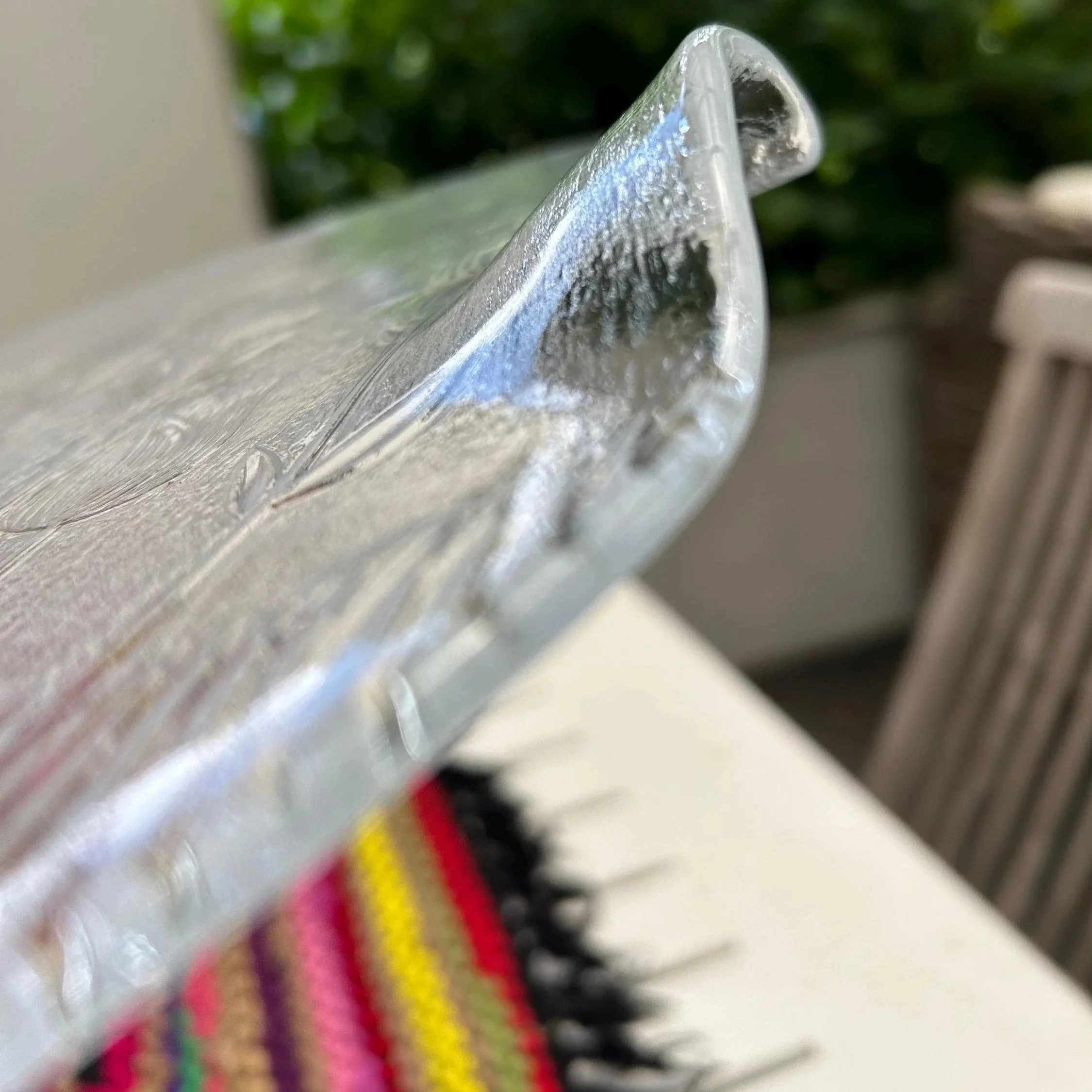 Close-up of textured glass and raised tulip etching.