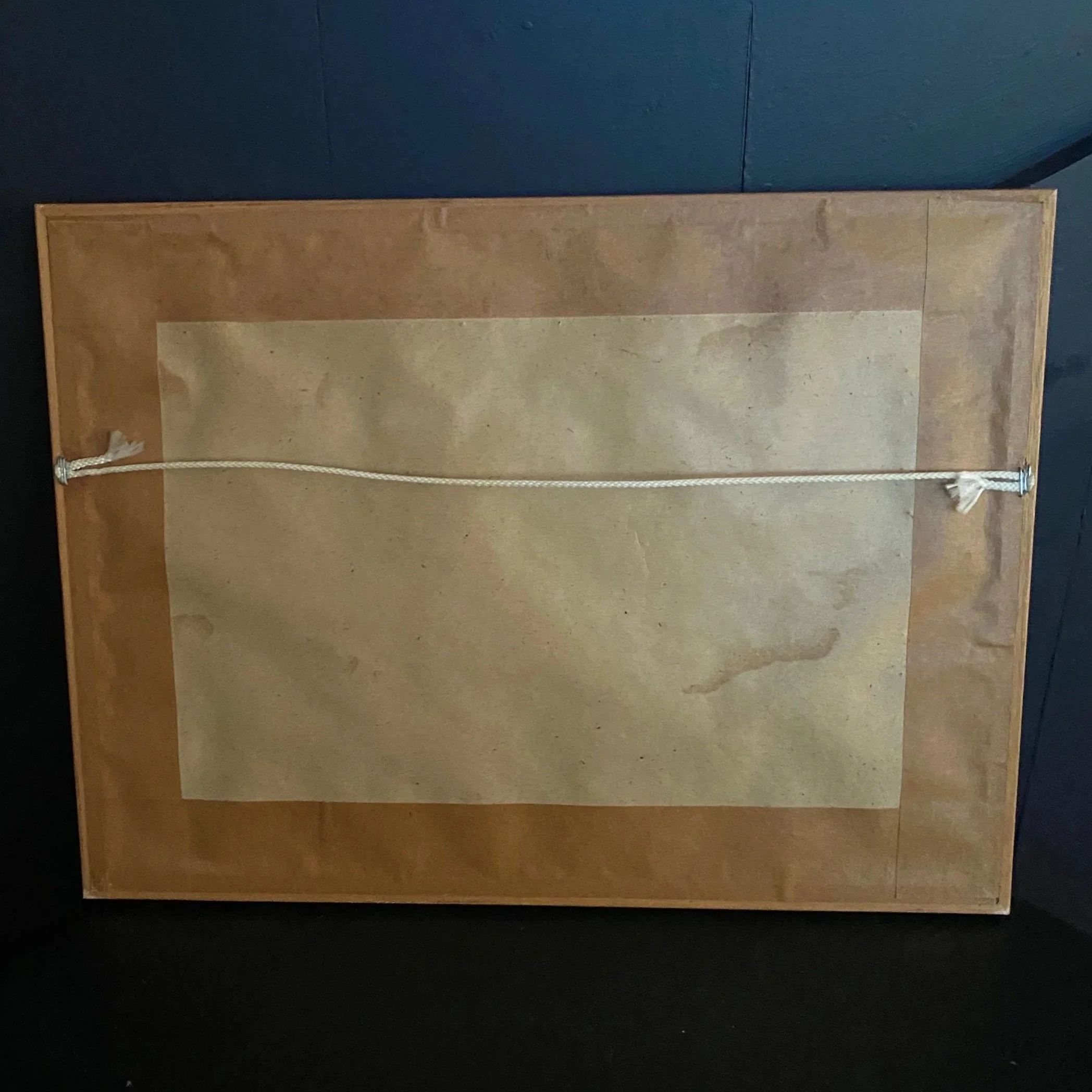 Back of the framed York Minster needlework artwork showing the paper backing and hanging cord