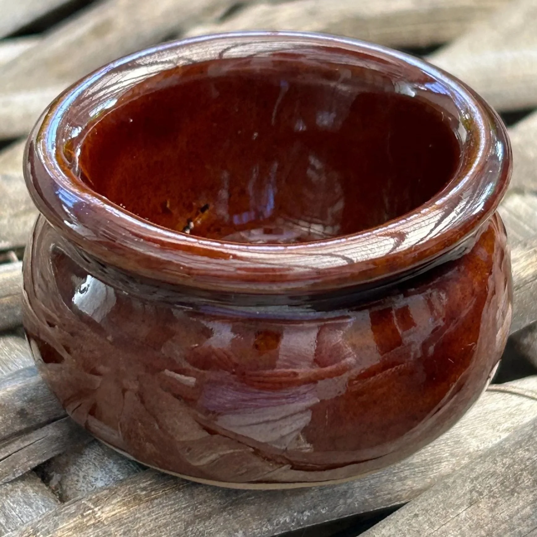 Moira Pottery salt cellar on rustic wicker surface – deep brown glaze