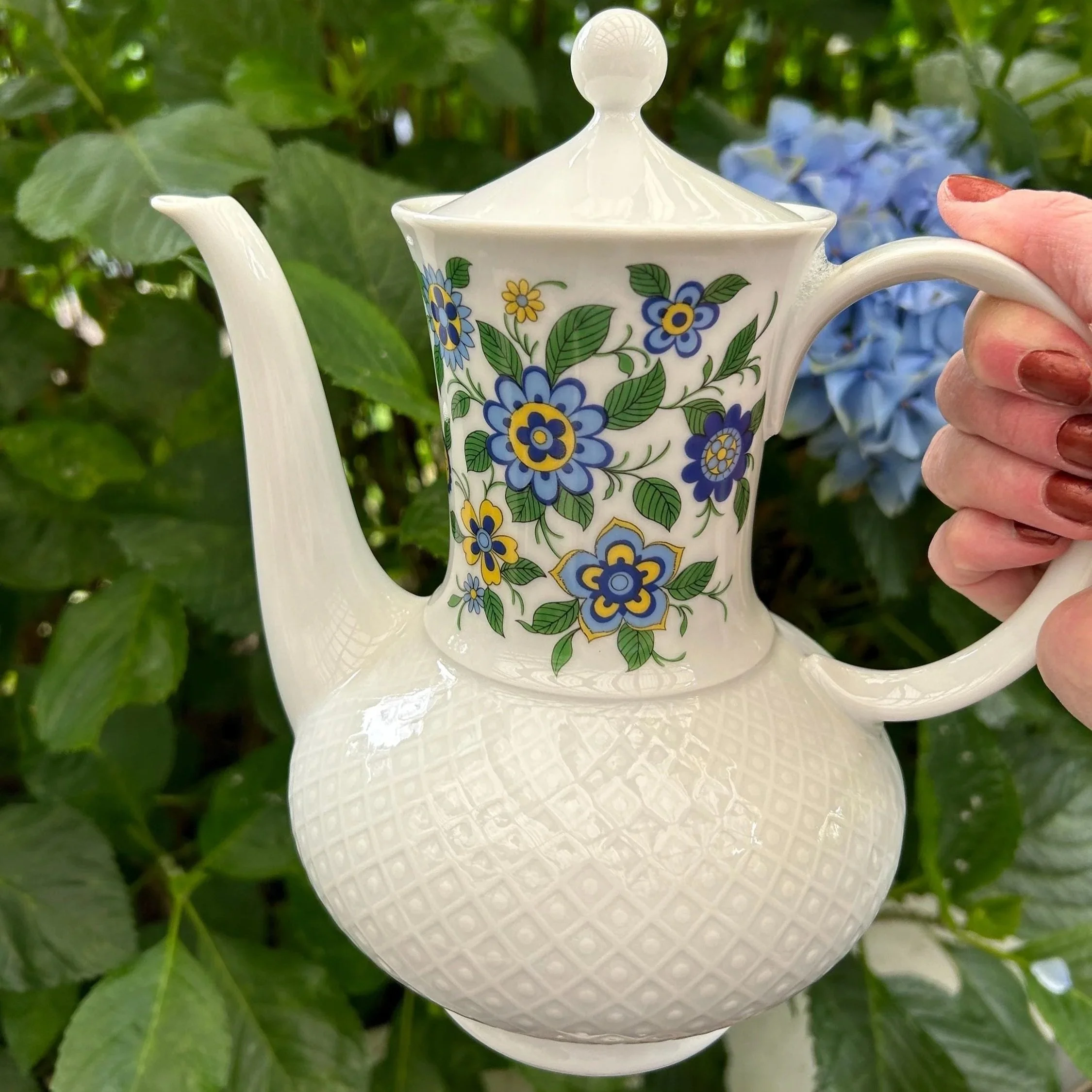 Full view of the Seltmann Weiden porcelain coffee pot with floral motif and textured base