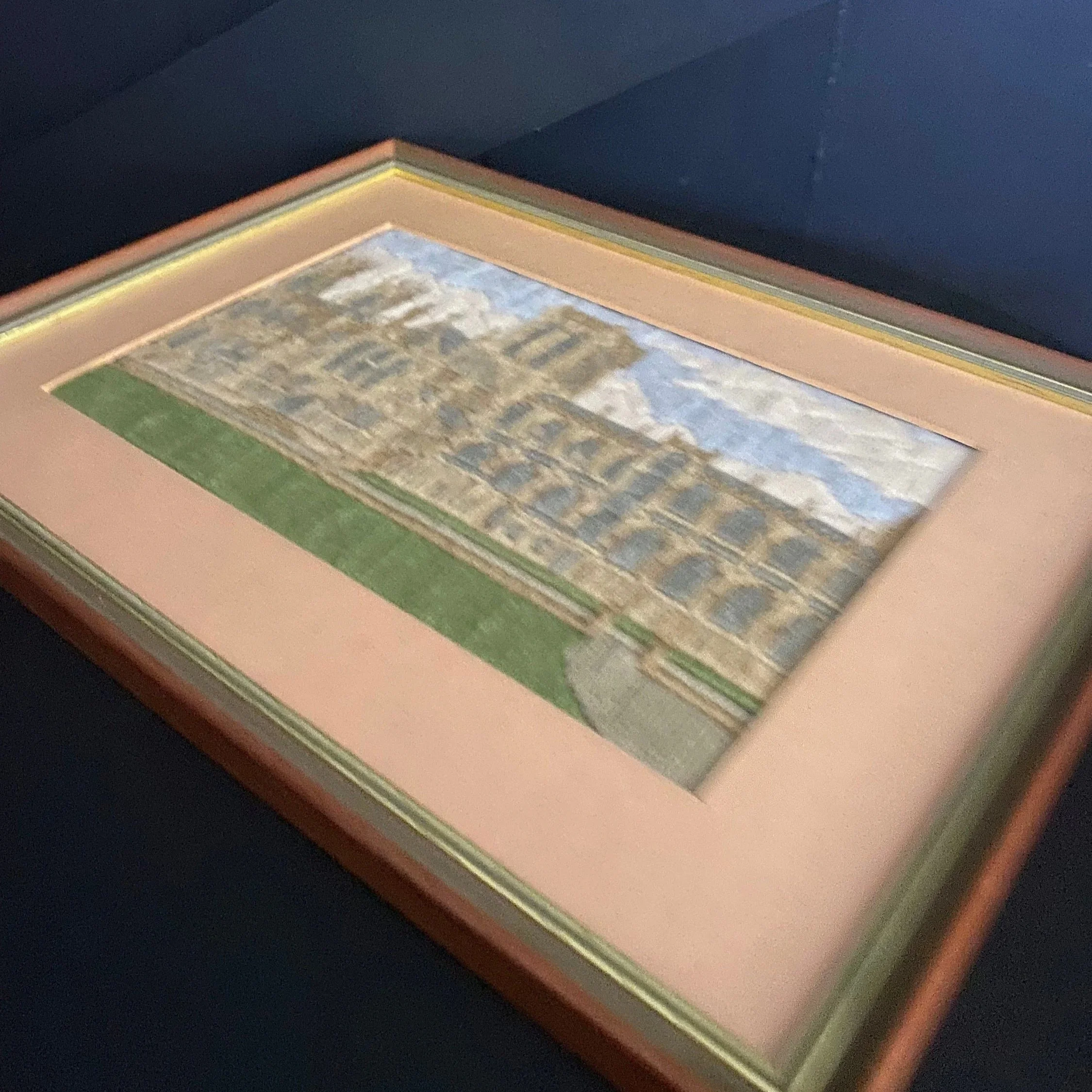 Angled view of the framed long stitch picture showing the depth of the frame and matting