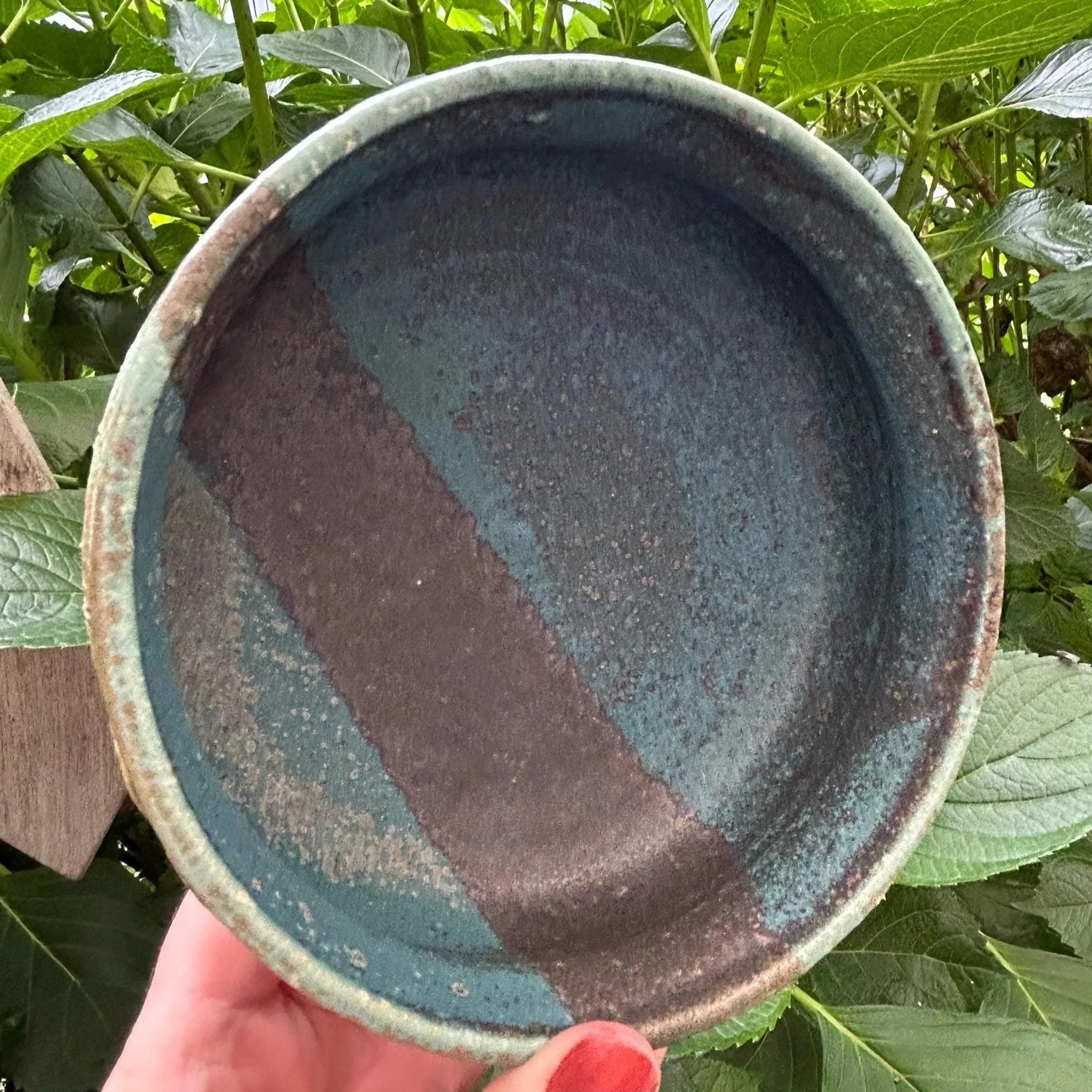 Overhead view of bowl held outdoors, showing size and glaze detail