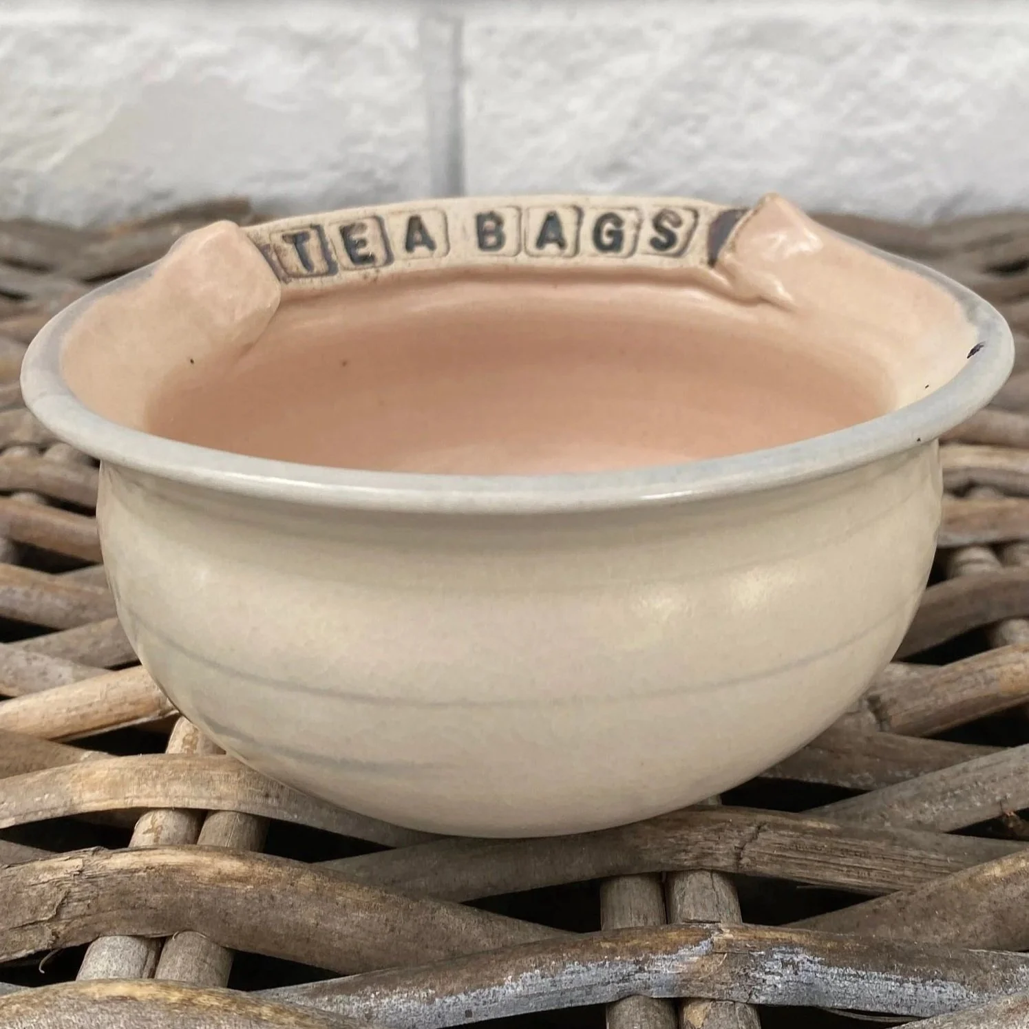 Side view of “TEA BAGS” bowl showing subtle two-tone glaze