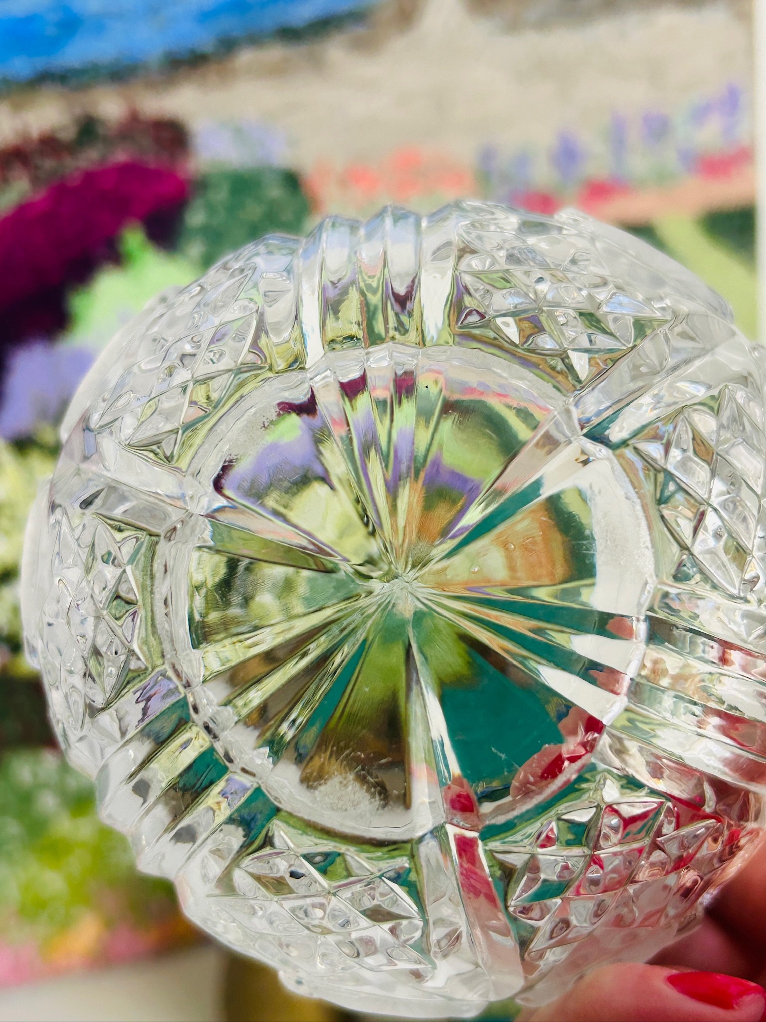 Underside view of the crystal dish showing the starburst base cut and the heavy clear lead crystal construction.
