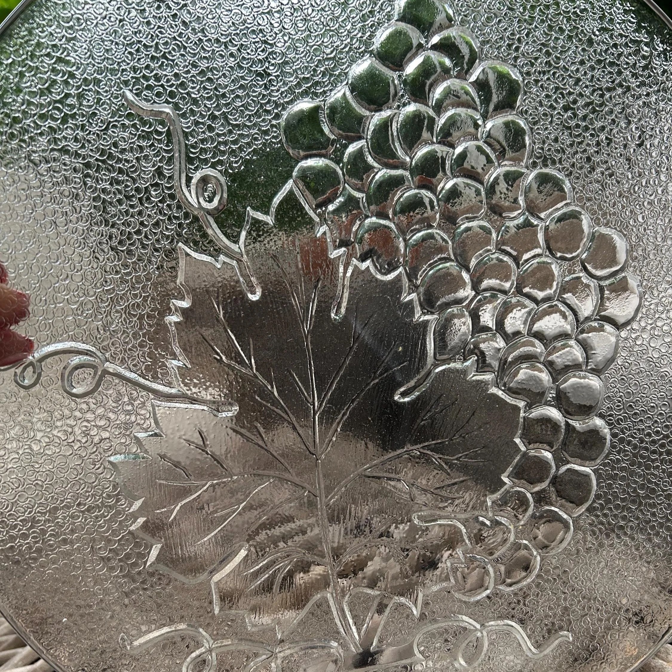 Close-up of embossed grape cluster and textured leaf detail