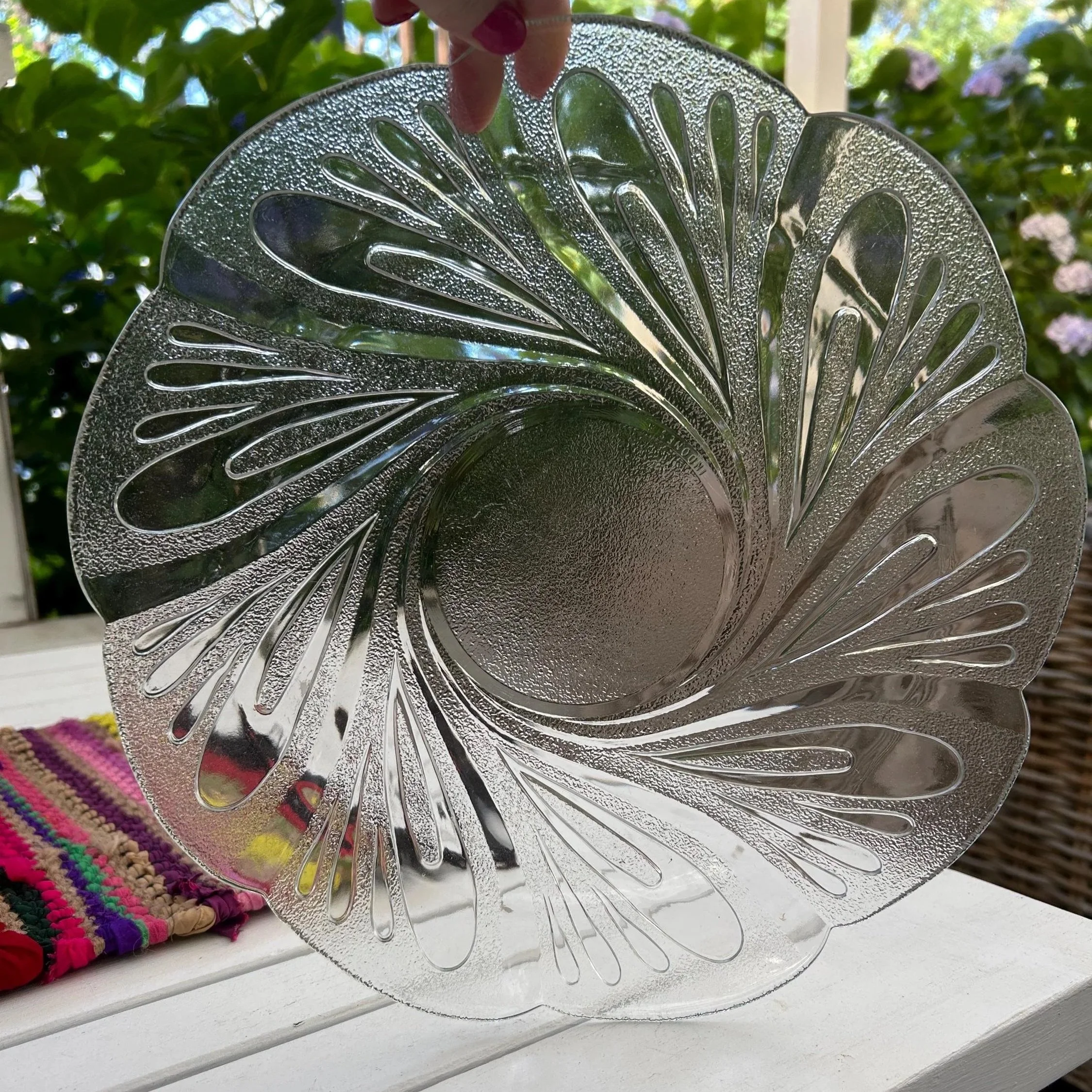 Overhead view of clear and frosted swirl plate on white table