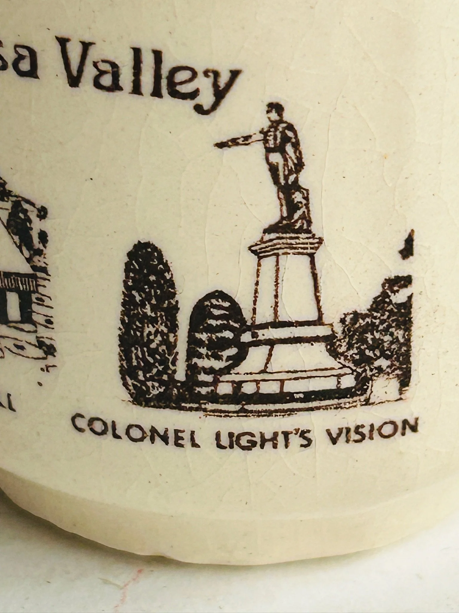 Close-up of the “Colonel Light’s Vision” illustration detail printed in black on the cream stoneware surface.