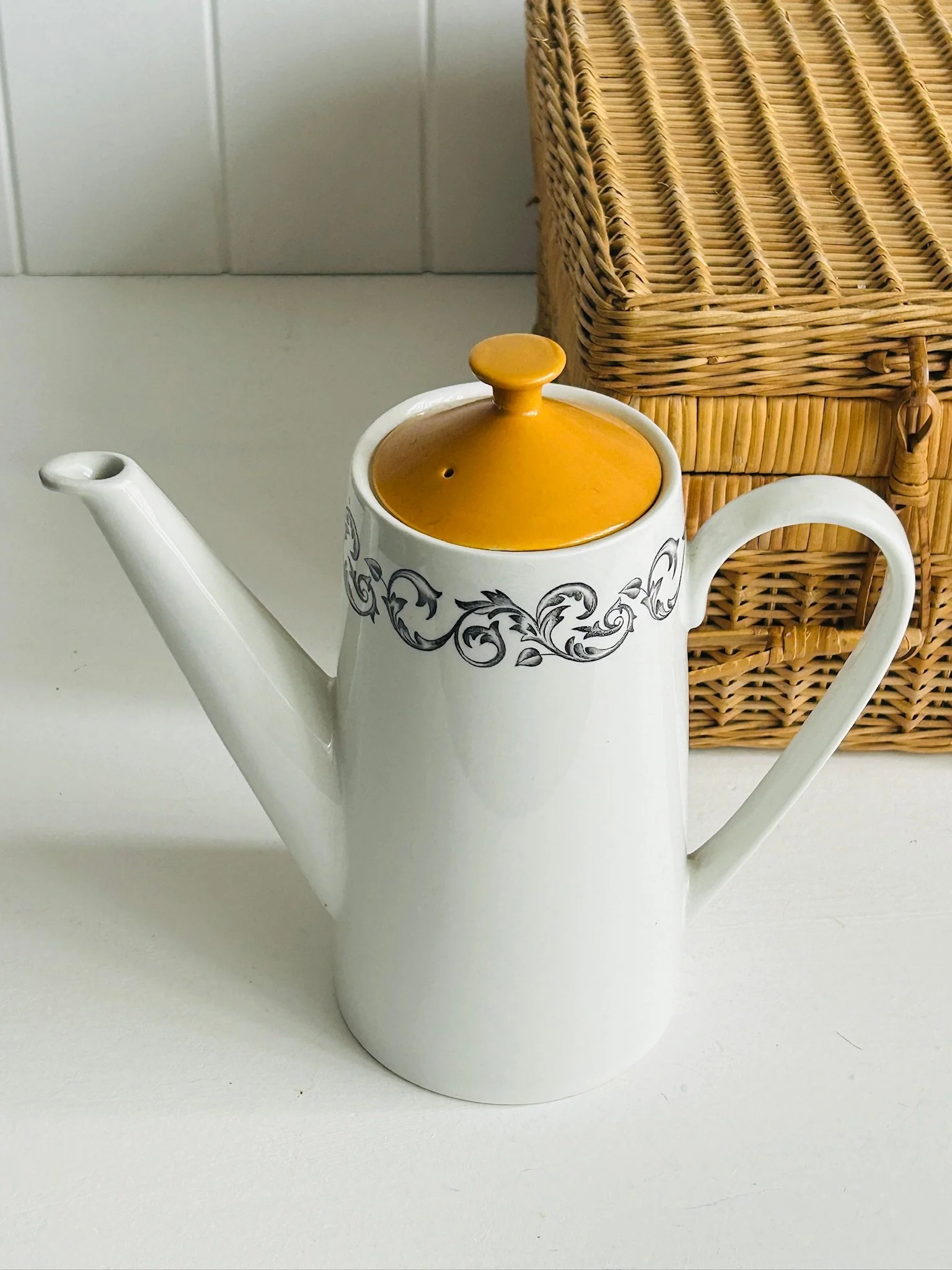 Full front angle of the vintage Johnson Brothers coffee pot with orange lid, showing the tall cylindrical form, sweeping handle, and decorative rim band.