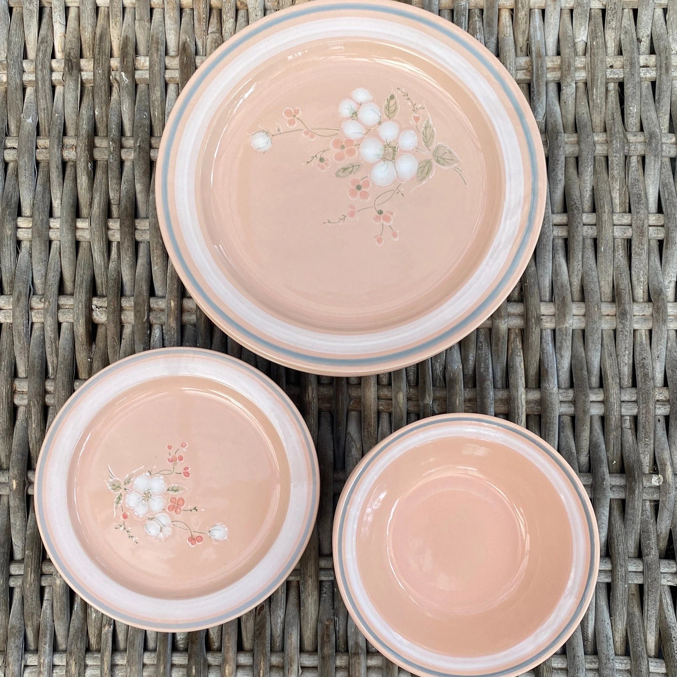 Essentials peach stoneware dinner plate and bowls showing floral pattern