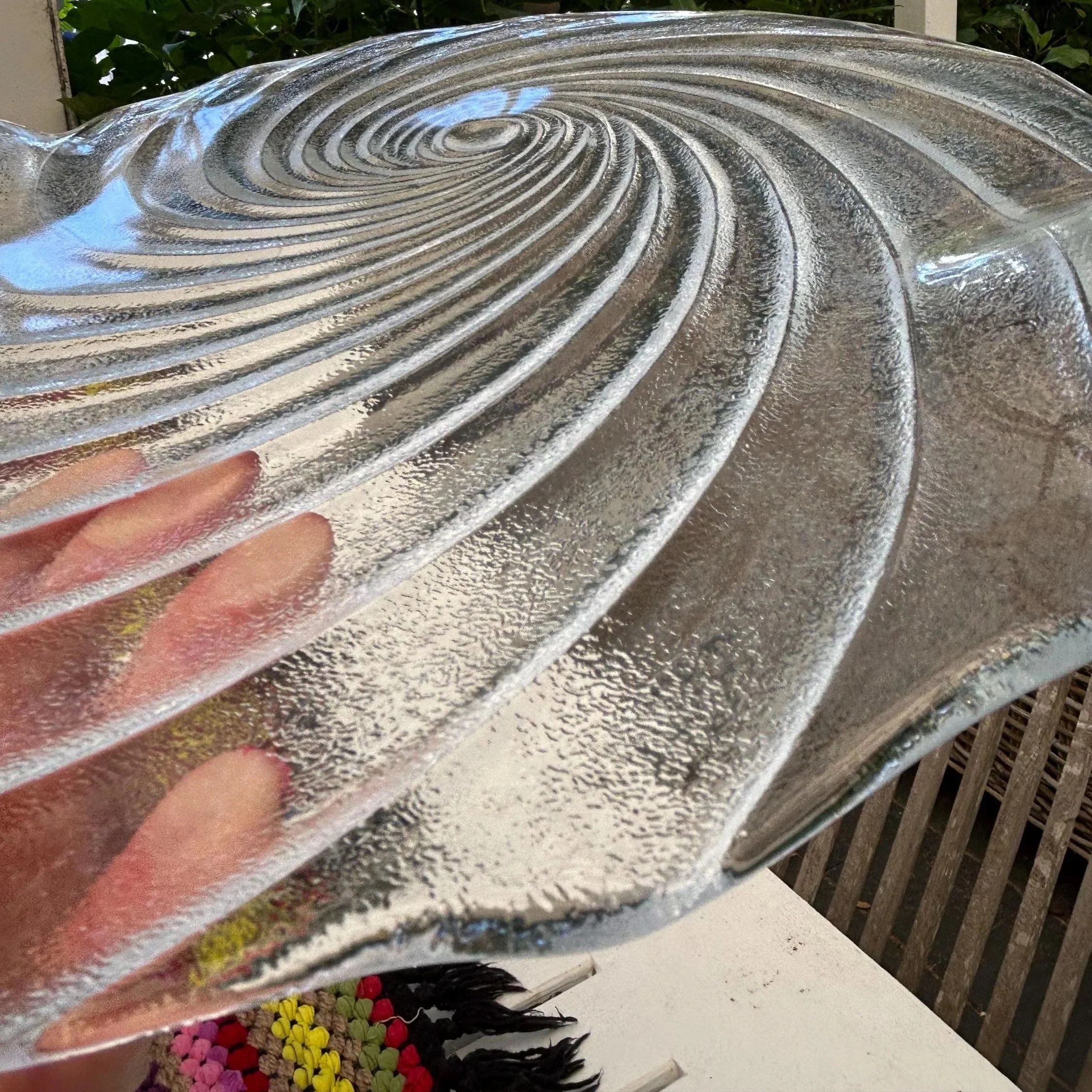 Angled view highlighting textured spiral grooves in clear glass.