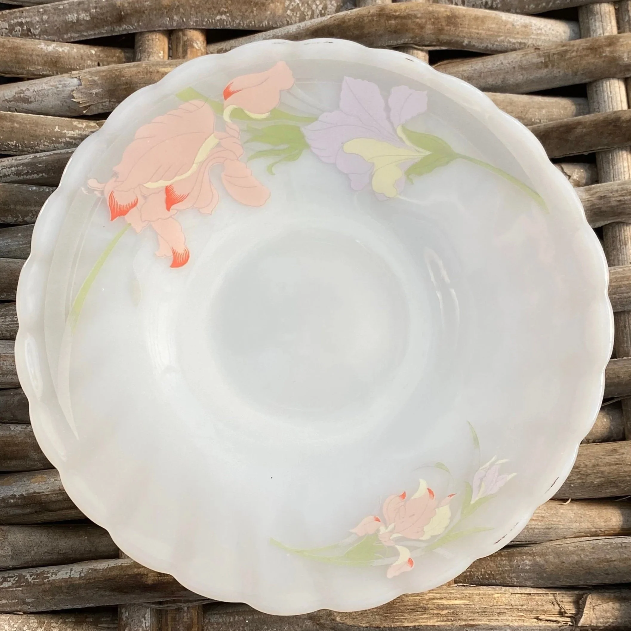 Cup and saucer laid flat, showcasing matching hand-painted motif