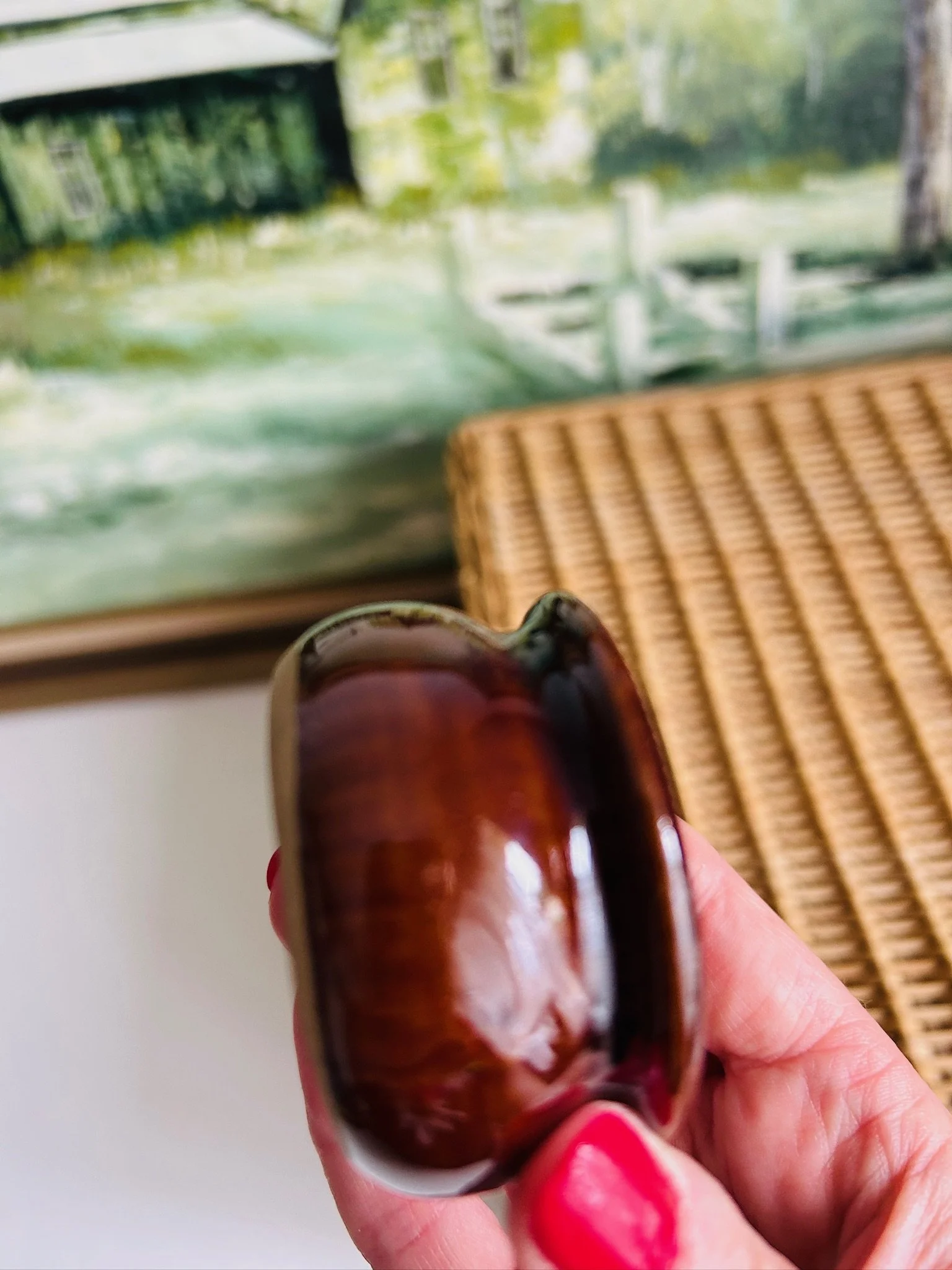 Close-up side detail of the Moira salt cellar held vertically, highlighting the curved profile and reflective glaze